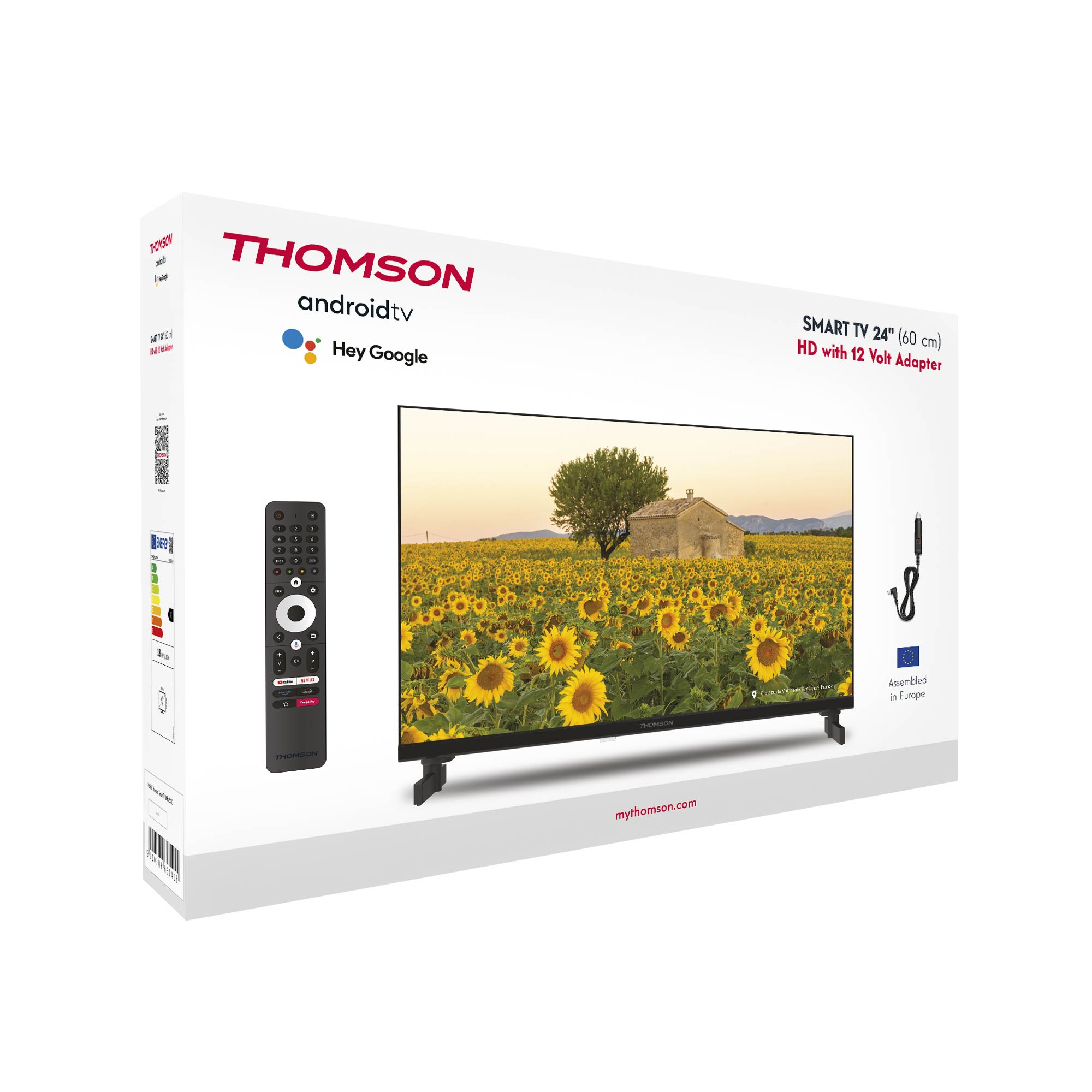 Caja de TV con un televisor mostrando girasoles, un mando a distancia y un cable negro.