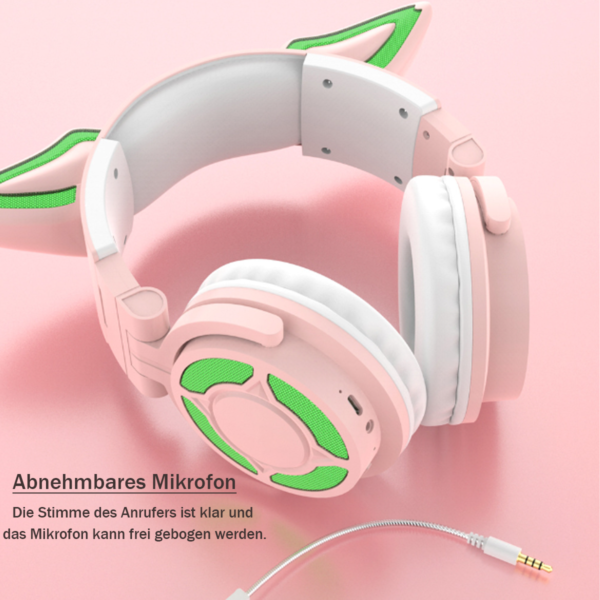 Pinke Kopfhörer mit Katzenohren. Die Ohrmuscheln haben grünes Netz. Ein abnehmbares Mikrofon und Kabel sind sichtbar.