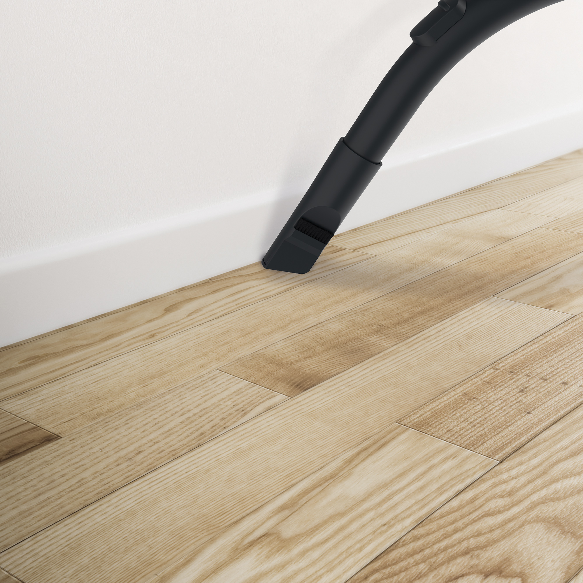 Dysza odkurzacza czyszcząca drewnianą podłogę obok białej ściany i listwy przypodłogowej.