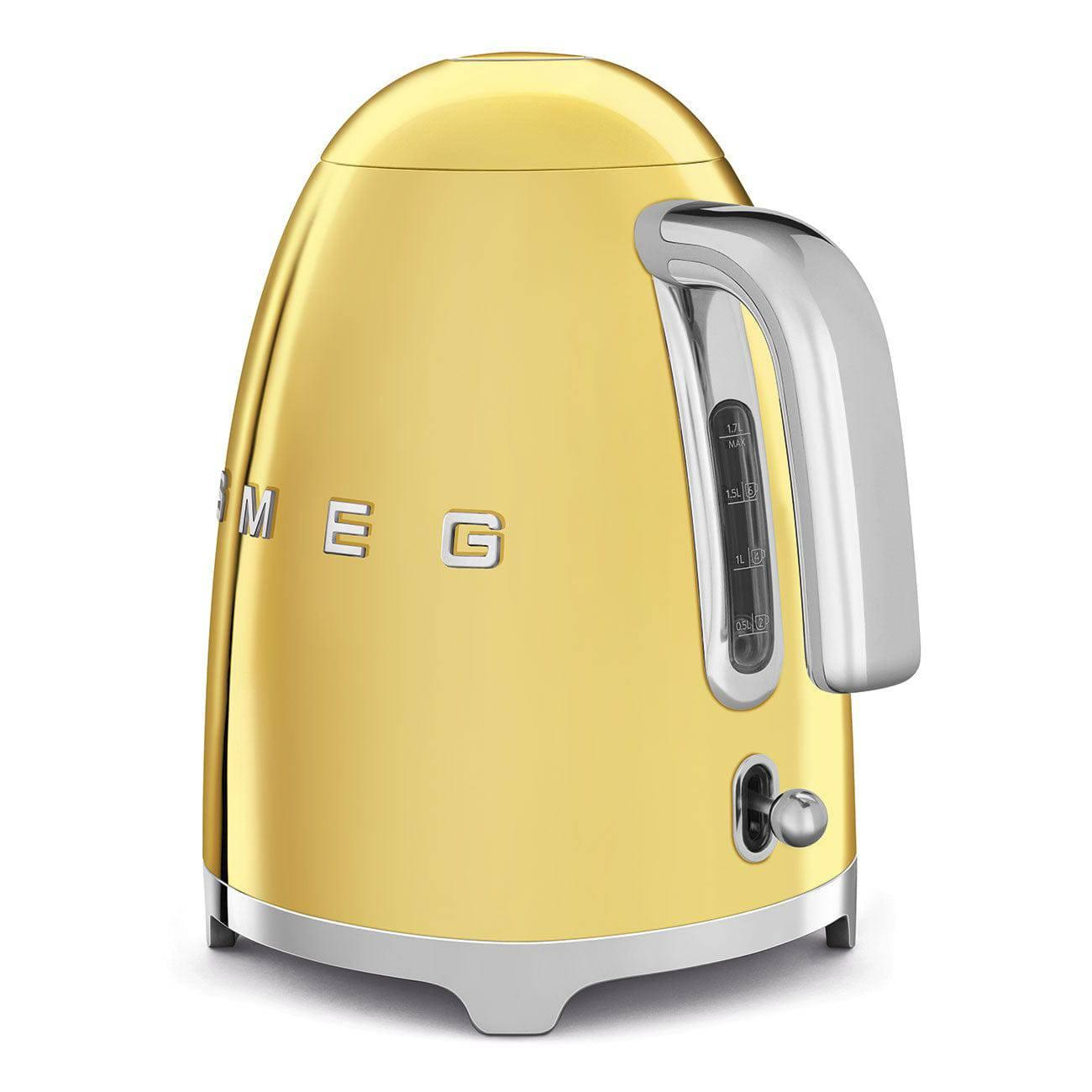 Gold-colored electric kettle with a silver handle and base. Water level indicator on the side. White background.