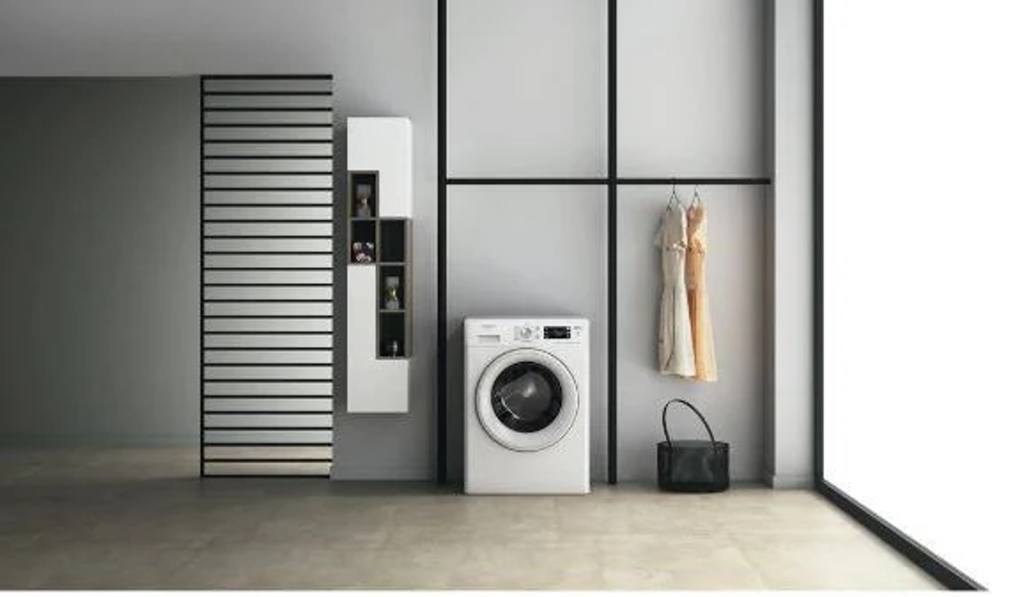Un lavadero moderno con lavadora blanca, vestidos y puerta corredera con pared gris.