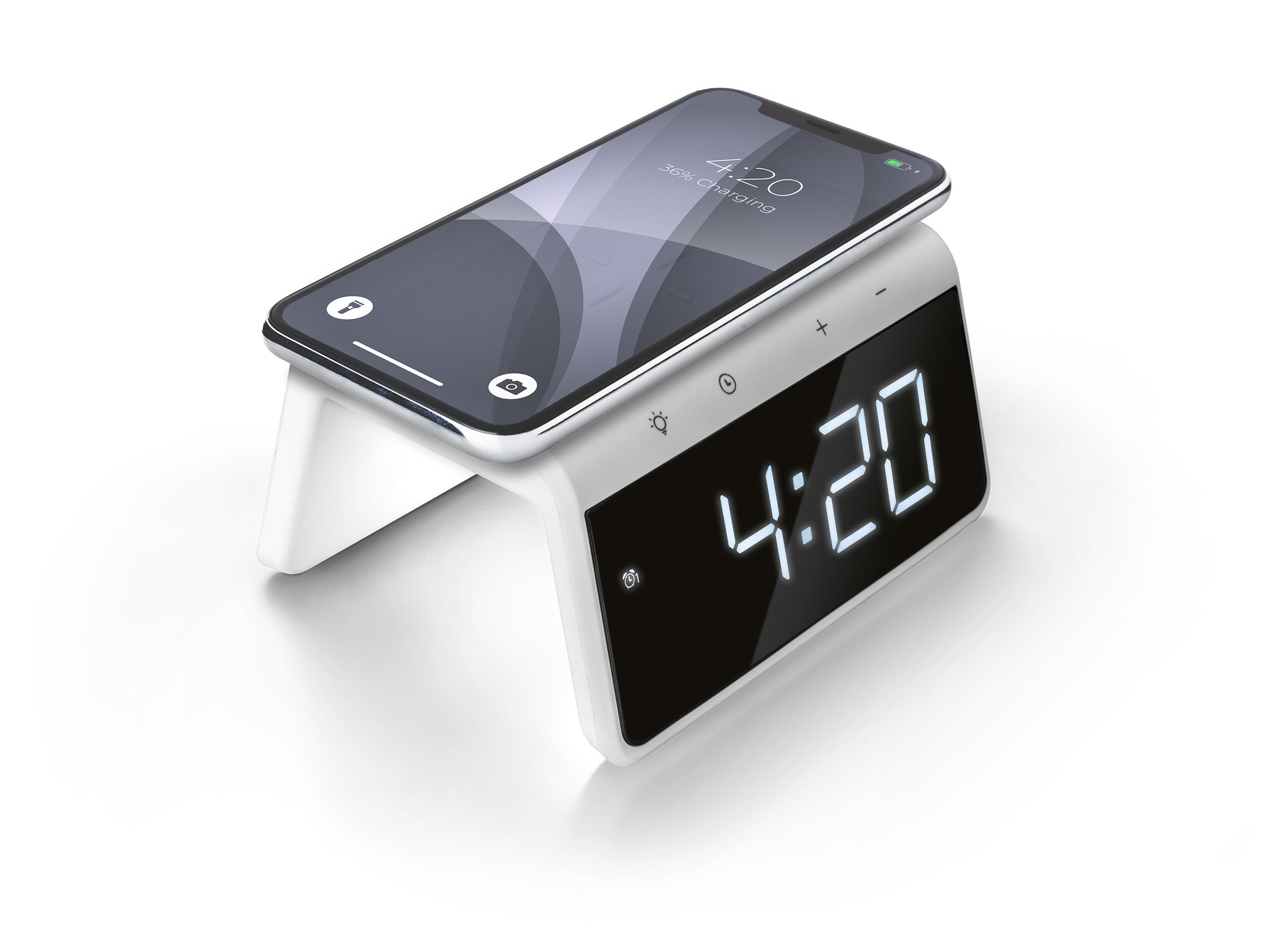 A white clock with a phone charging on top, showing the time.