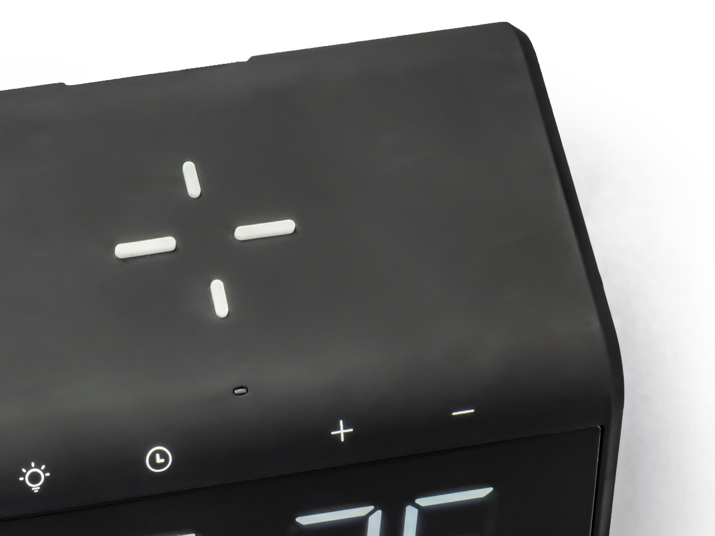 Close-up of black device with white buttons and a digital display.