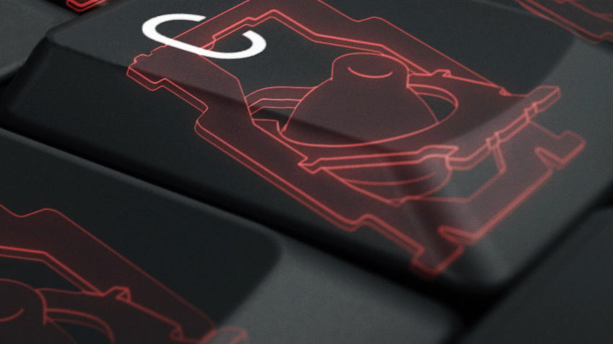 Nahaufnahme von schwarzen Tastaturtasten mit roten Symbolen. Eine Taste zeigt ein rotierendes Zahnradsymbol.