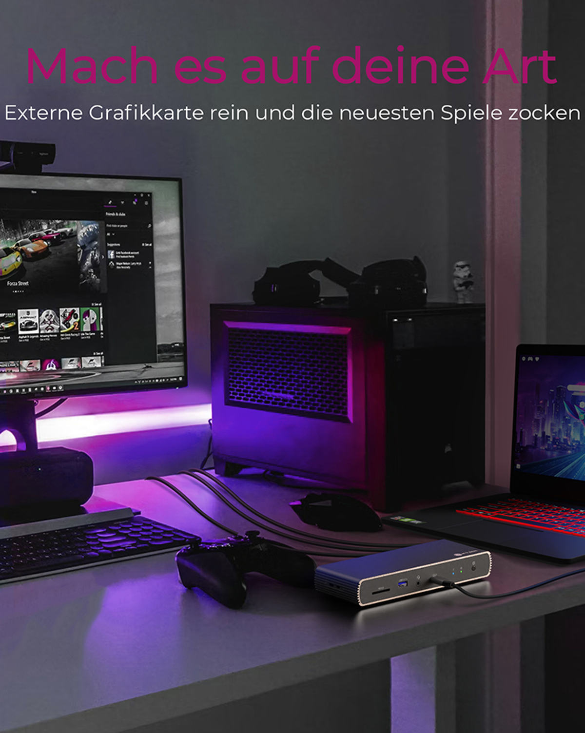 Schreibtisch-Setup mit Computer, Monitor und Gaming-Zubehör, beleuchtet mit lila Licht.
