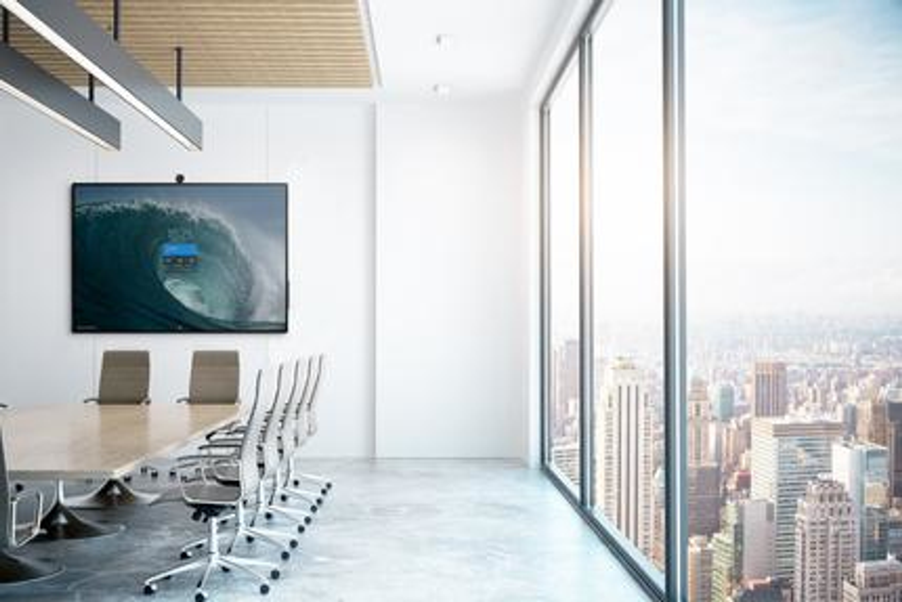 Bureau moderne avec de grandes fenêtres. Table, chaises et écran affichant une vague.