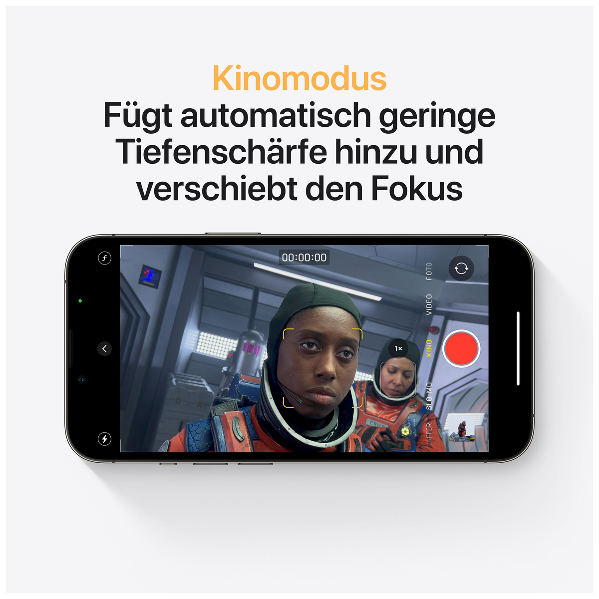 Telefon wyświetlający wideo z osobą w skafandrze kosmicznym i czerwonym przyciskiem nagrywania.