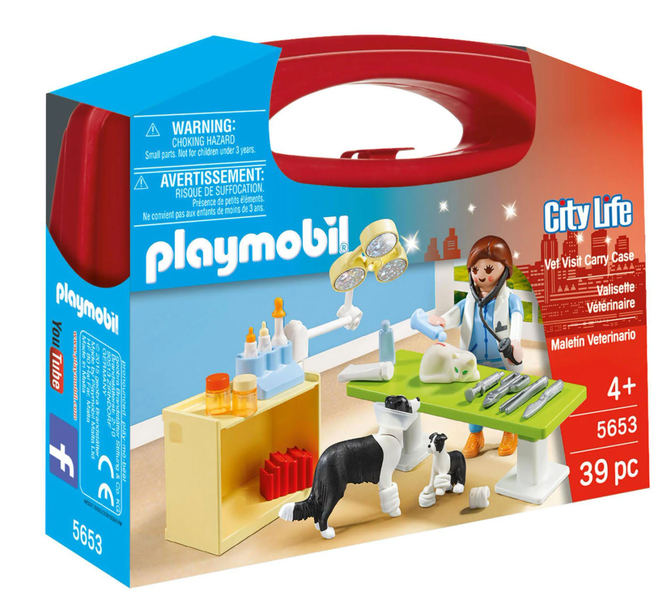 Set veterinario Playmobil con veterinario, cane, strumenti e un tavolo. È in una scatola blu e rossa.