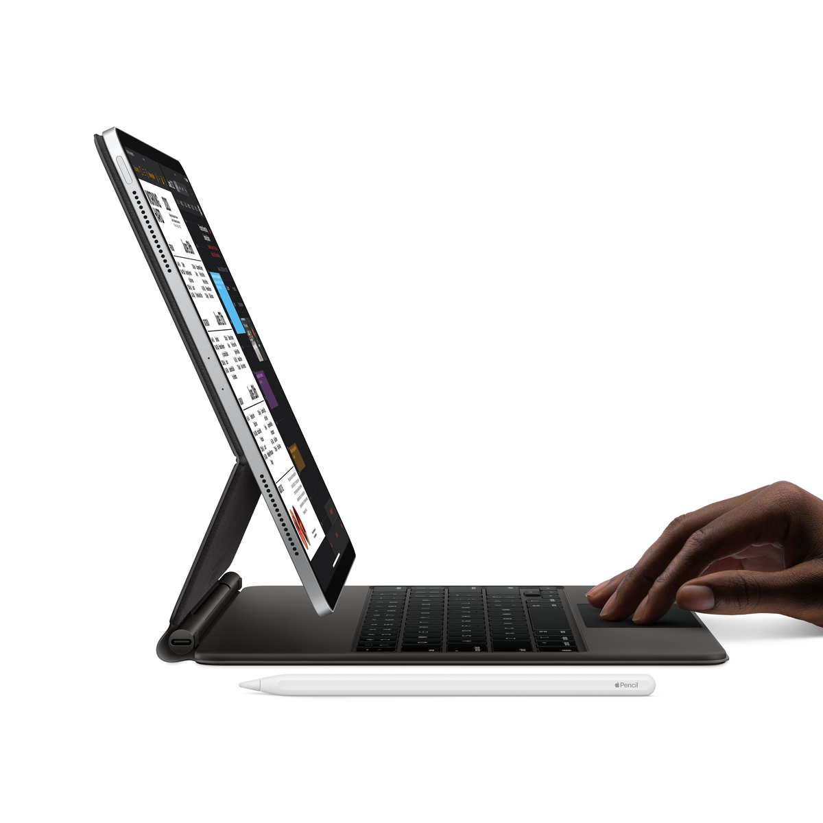 Tablet z klawiaturą i rysikiem. Ręka jest na gładziku.