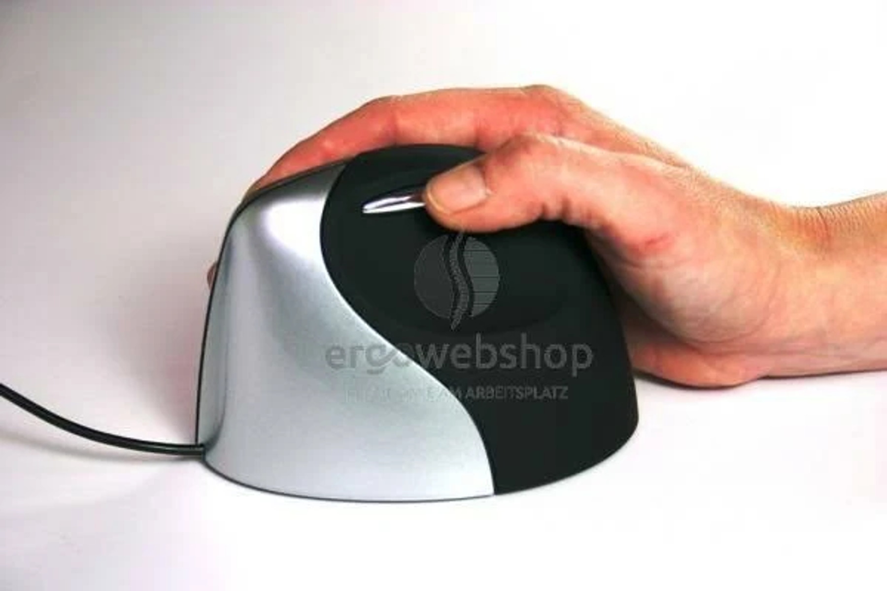 A hand rests on a black and silver ergonomic mouse. The mouse has a scroll wheel, and a black cord is visible.