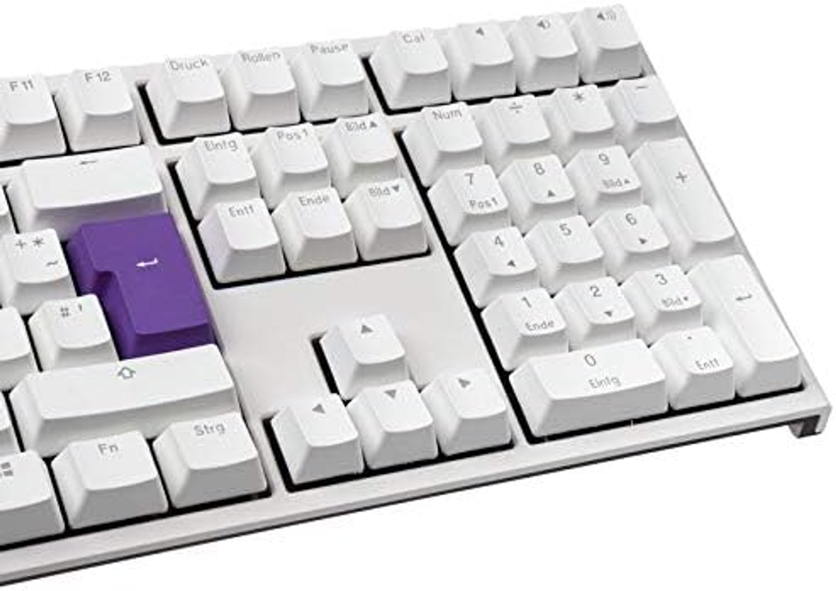 Biała klawiatura, niektóre klawisze są fioletowe. Klawisz 'Enter' jest fioletowy. Białe tło.
