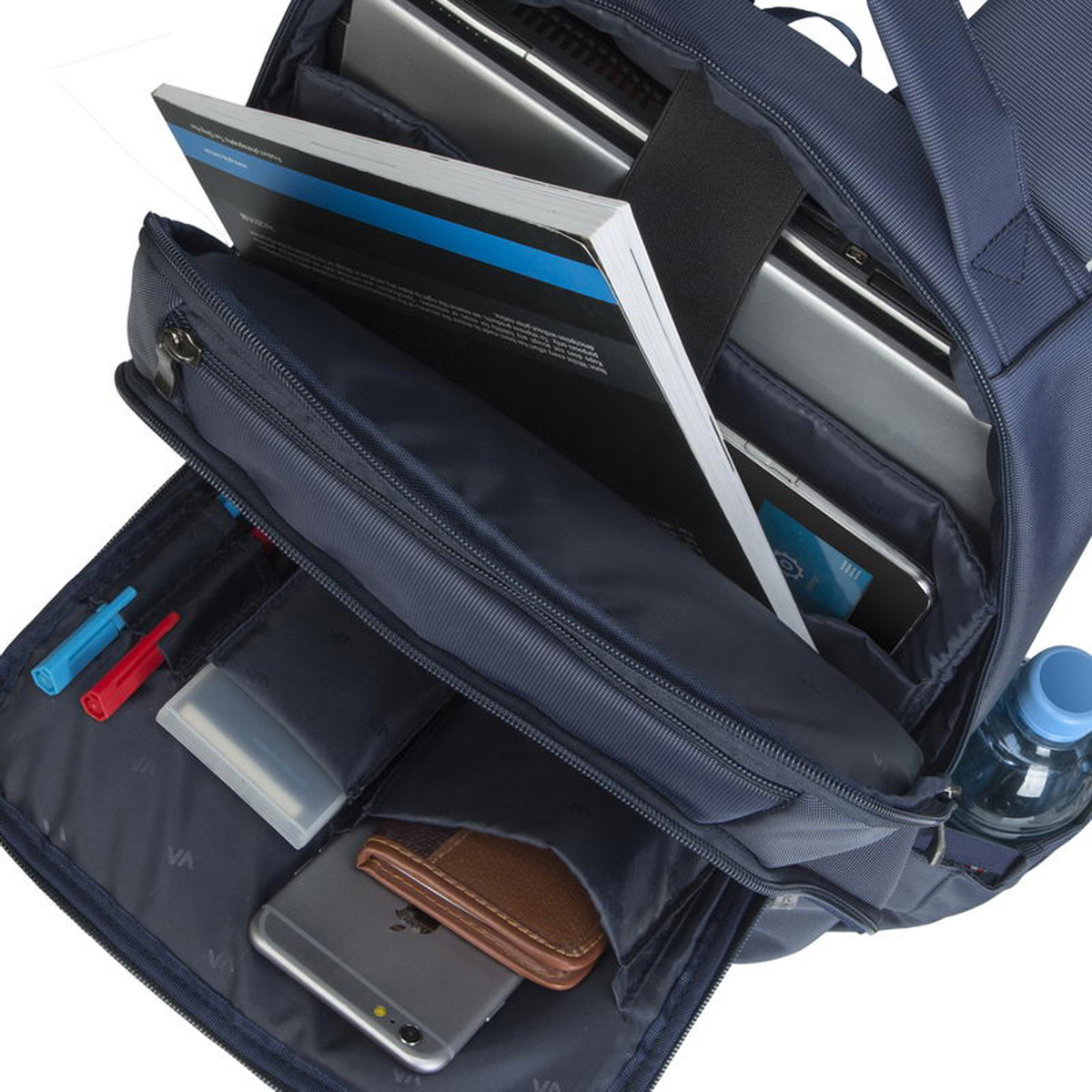 Zaino blu aperto con libri, laptop, tablet, telefono, portafoglio, penne e bottiglia d'acqua.