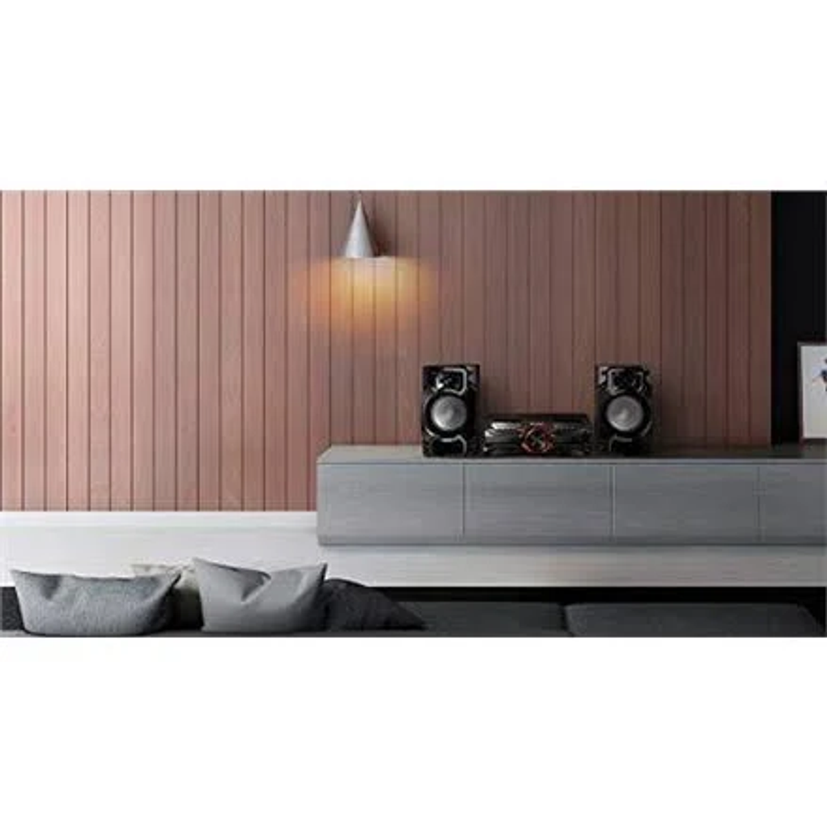 Soggiorno con impianto stereo su un mobile grigio. Parete con pannelli in legno, luci e cuscini presenti.
