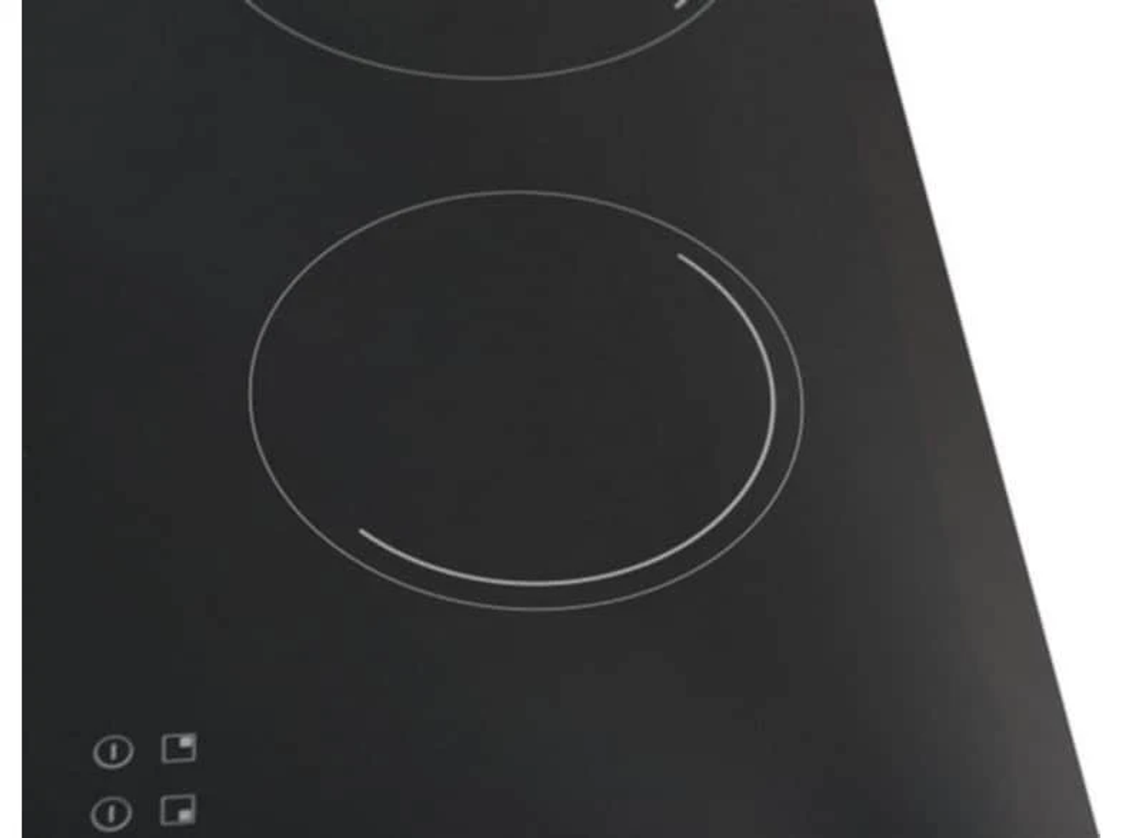 Zbliżenie czarnej płyty grzewczej z dwoma okrągłymi elementami grzejnymi.