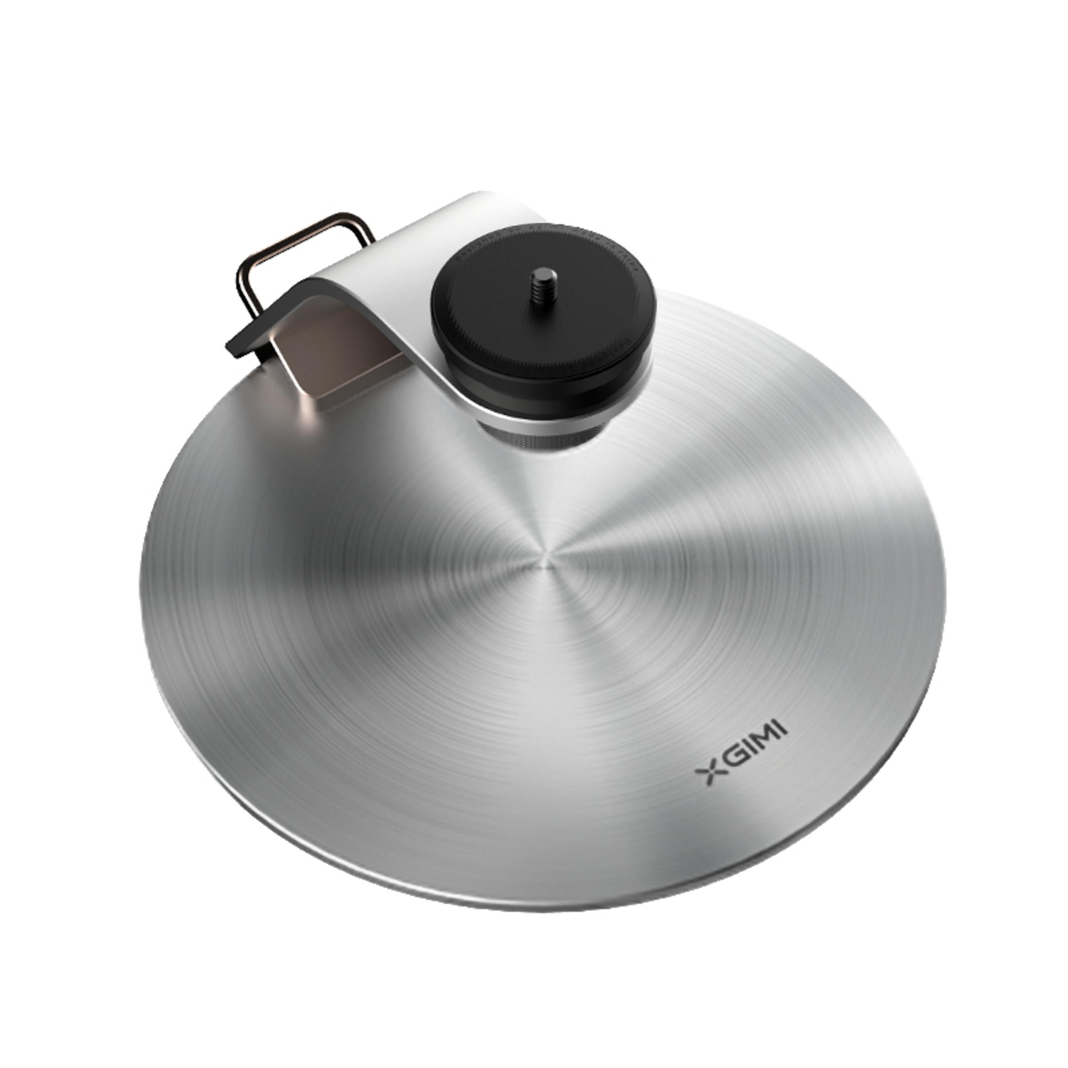 Srebrny stojak w kształcie dysku. Czarna górna część ze śrubą. Metalowy uchwyt na górze.