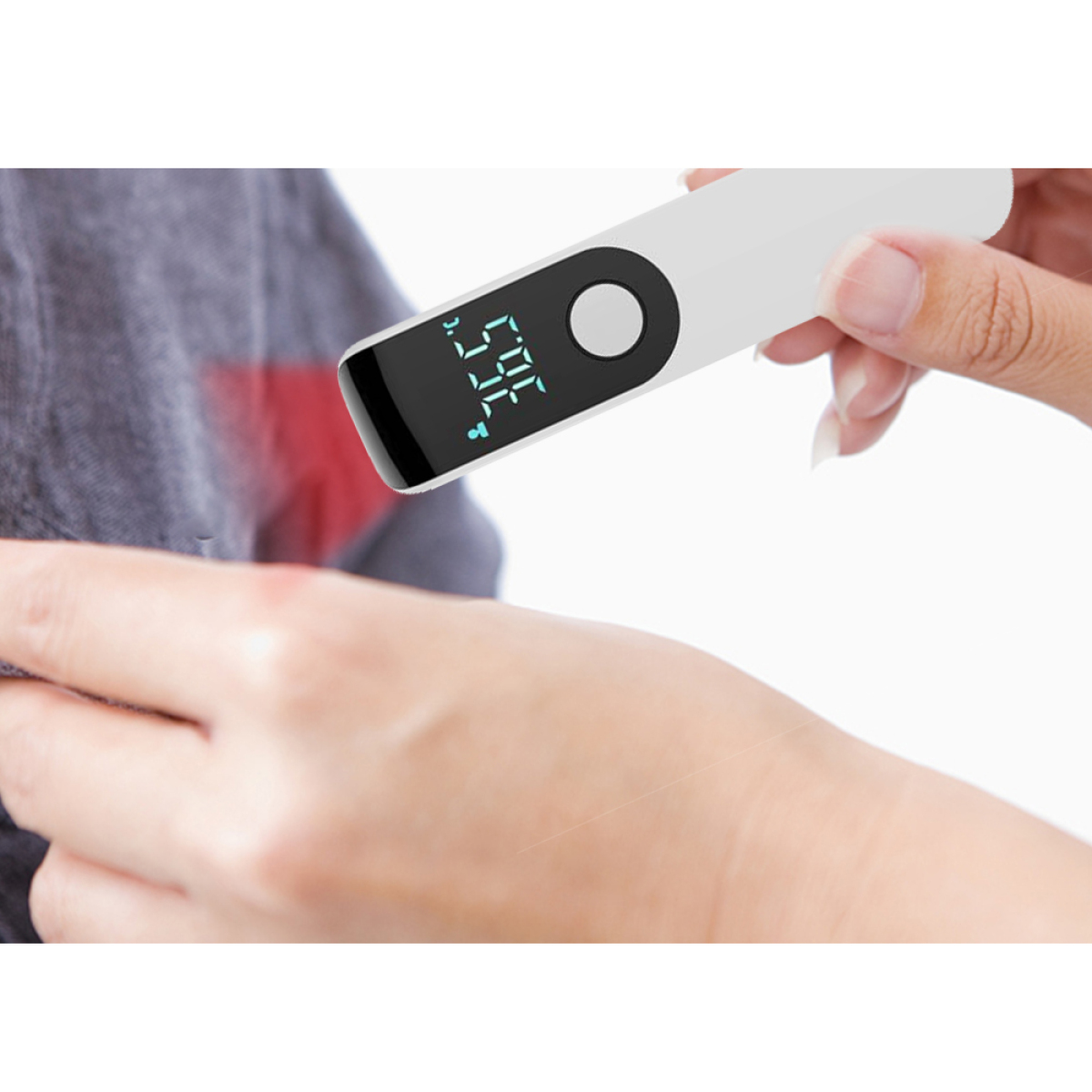 Die Hand einer Person, die ein Thermometer auf gereizter roter Haut hält.