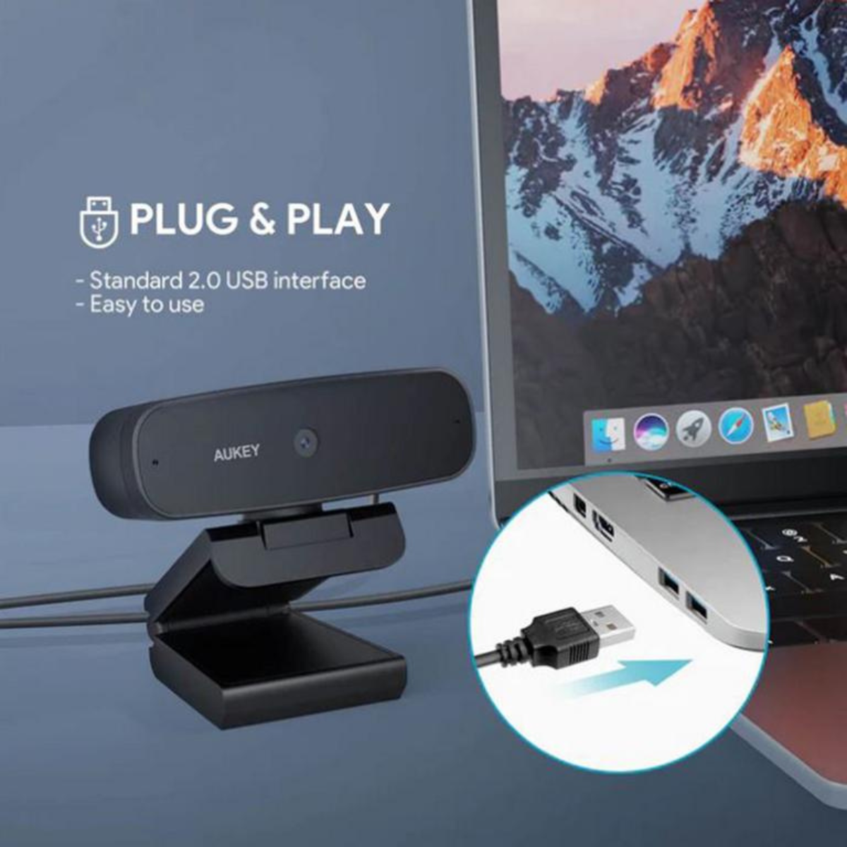 Schwarze Webcam auf einem Ständer mit einem Laptop, der den USB-Anschluss zeigt.
