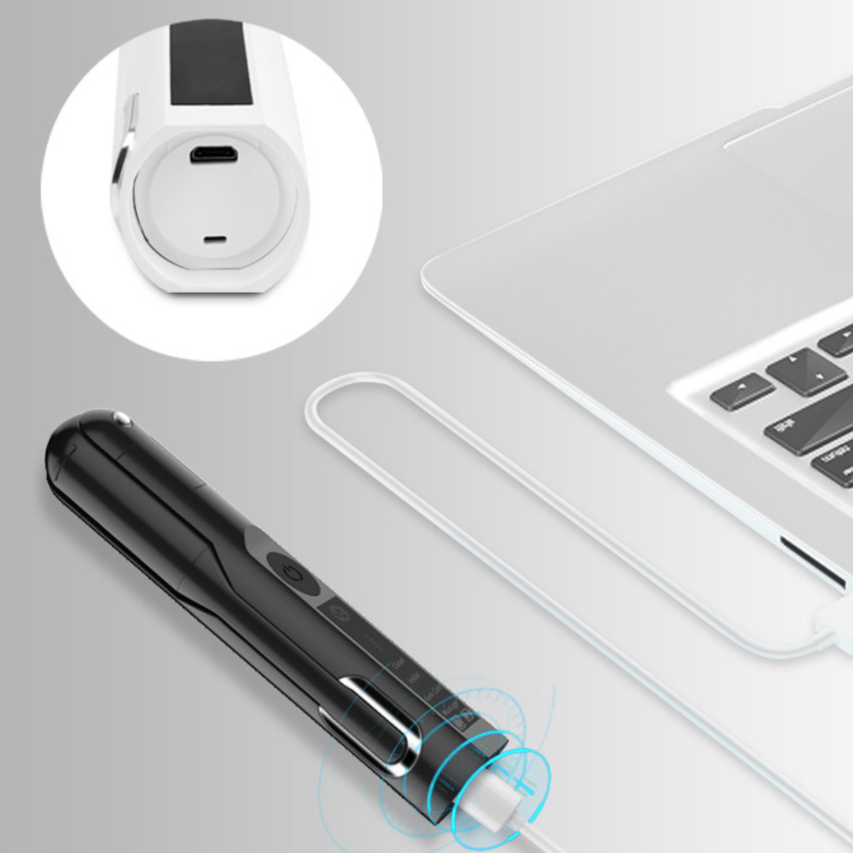 Schwarz-weißes Gerät mit Ladekabel, das mit einem Laptop verbunden ist.