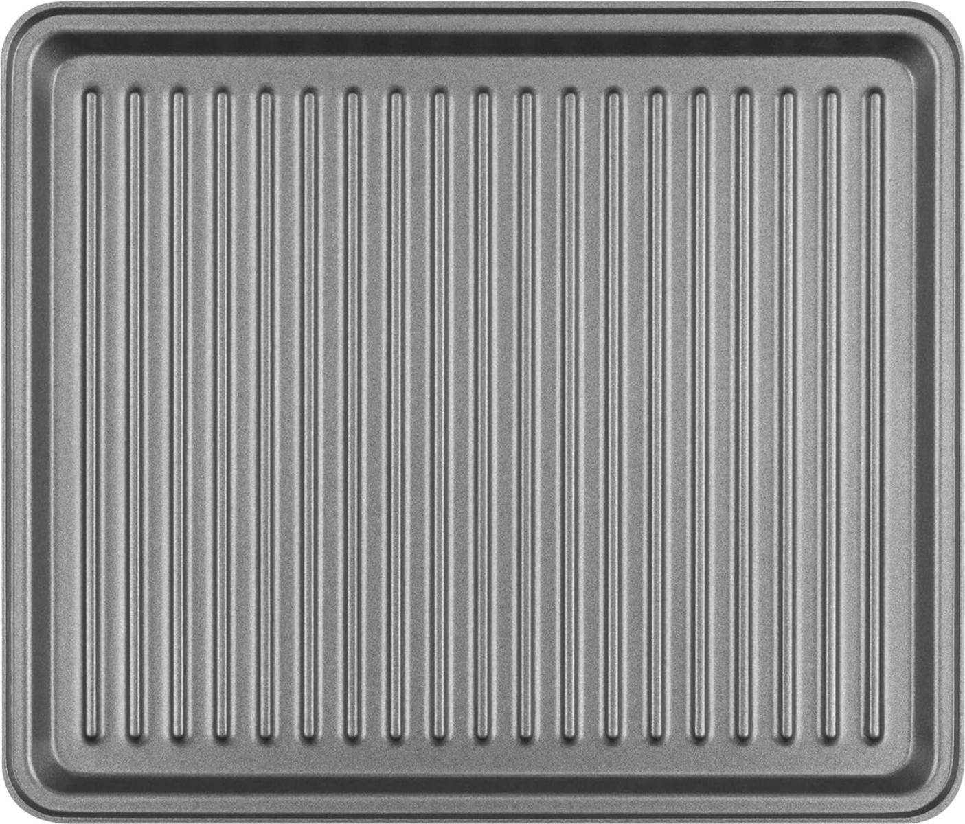 A silver metal baking tray with vertical ridges fills the frame, against a white background.