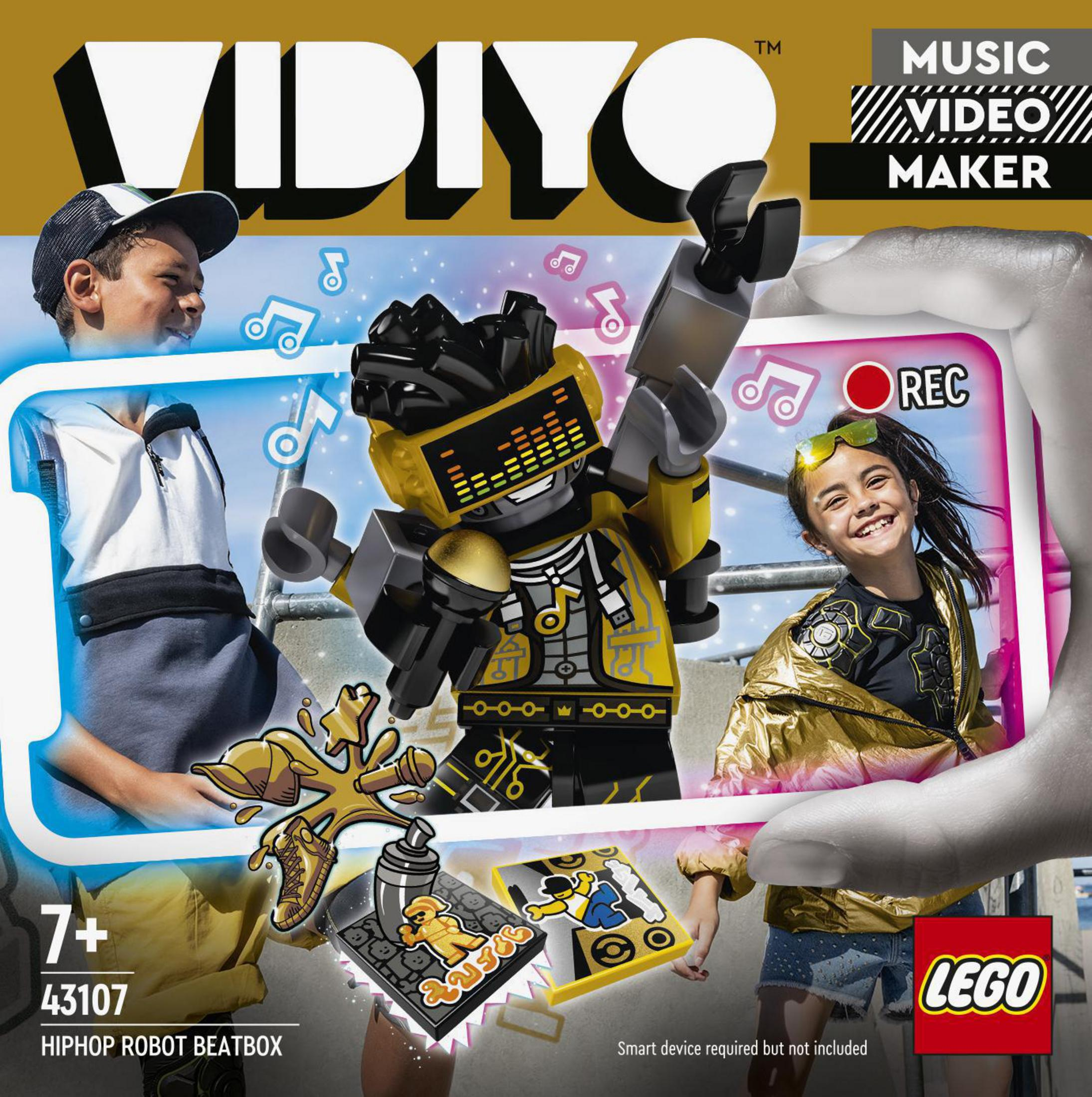 Eine Lego-Box mit einem Roboter und zwei Kindern. Die Box wird in einer Hand gehalten.