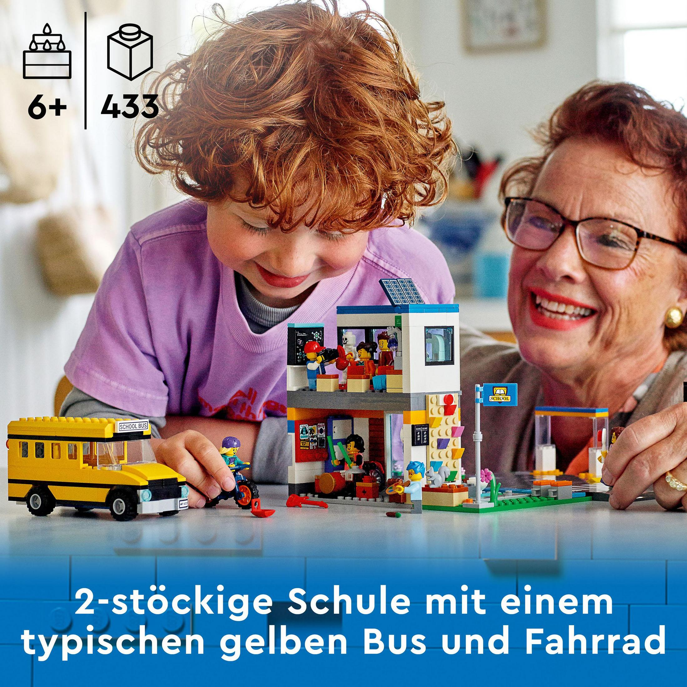 Lego set: child and woman building a school with yellow bus and a bike.