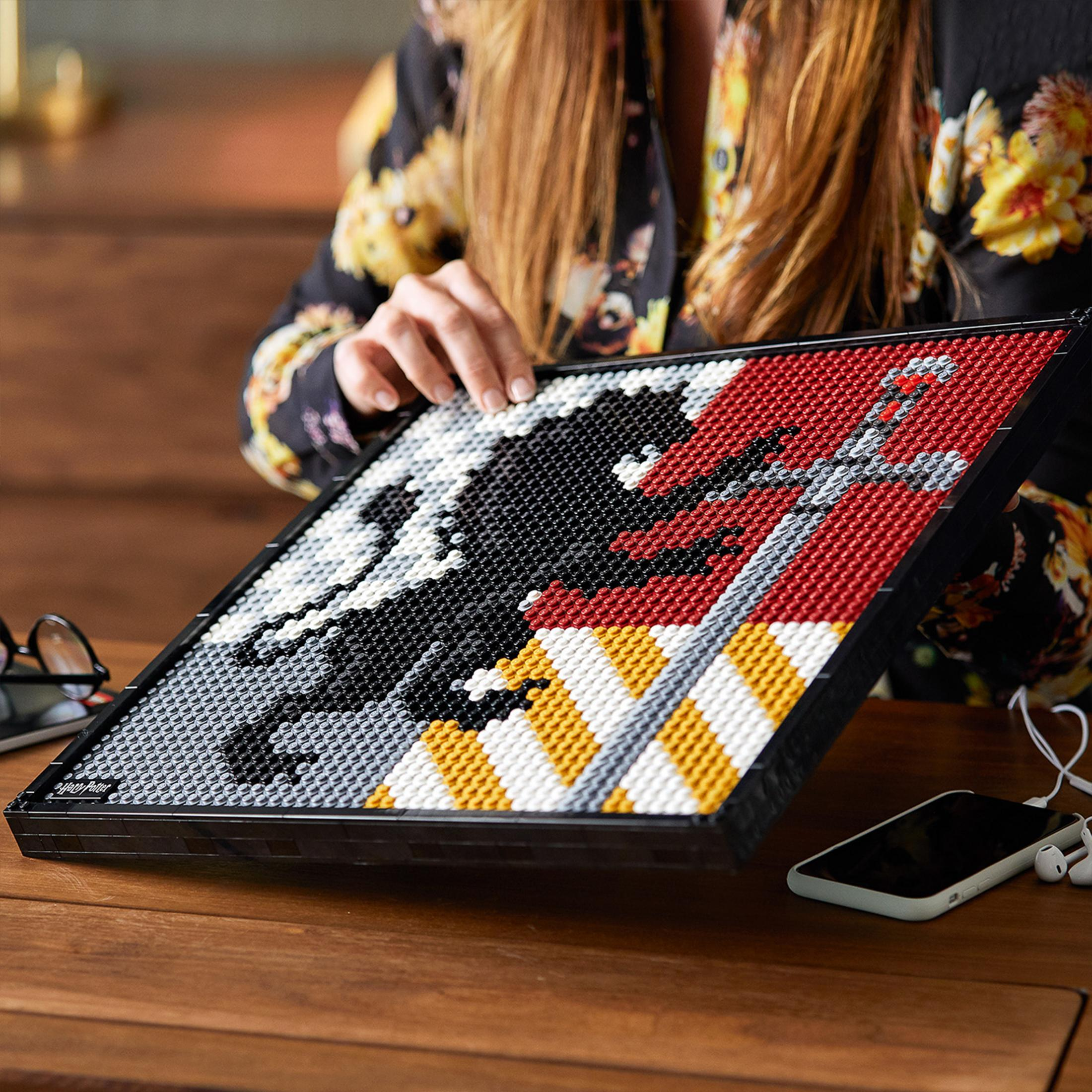 A Lego art piece depicting a black lion with a sword on a red and white background.