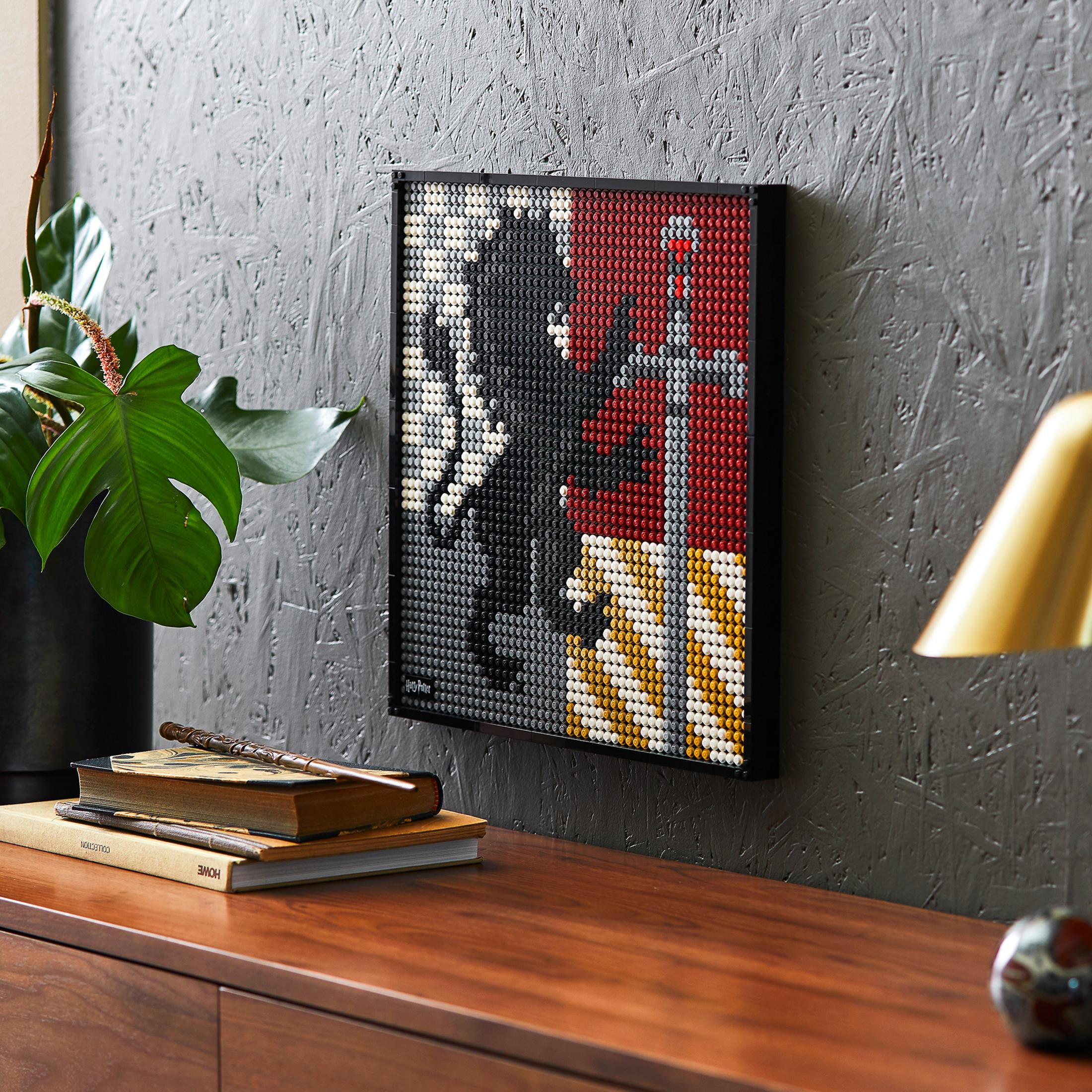 A Lego art piece on a wall, featuring a black and white image with a red and yellow background.