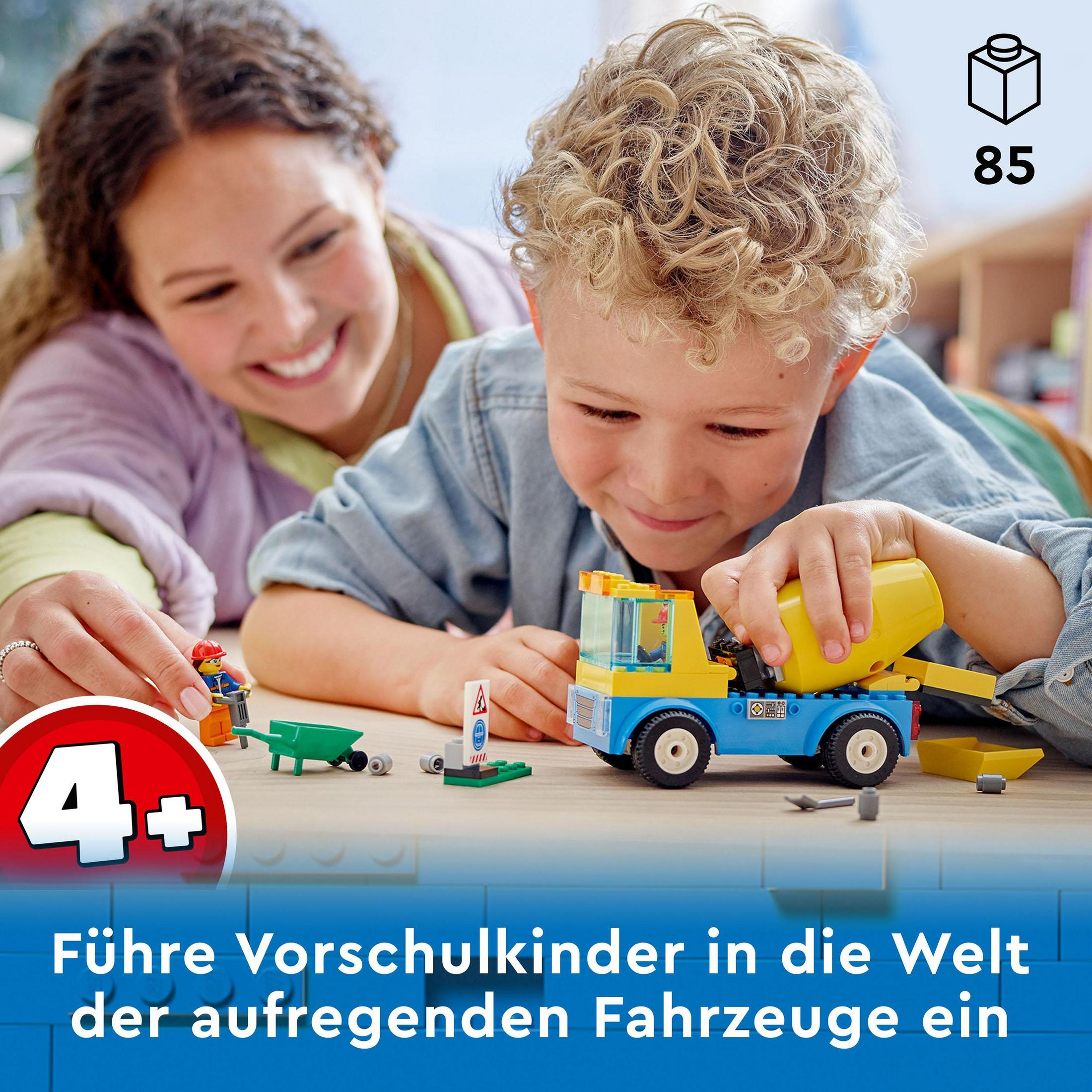 Niños jugando con un camión de construcción de juguete con bloques Lego.