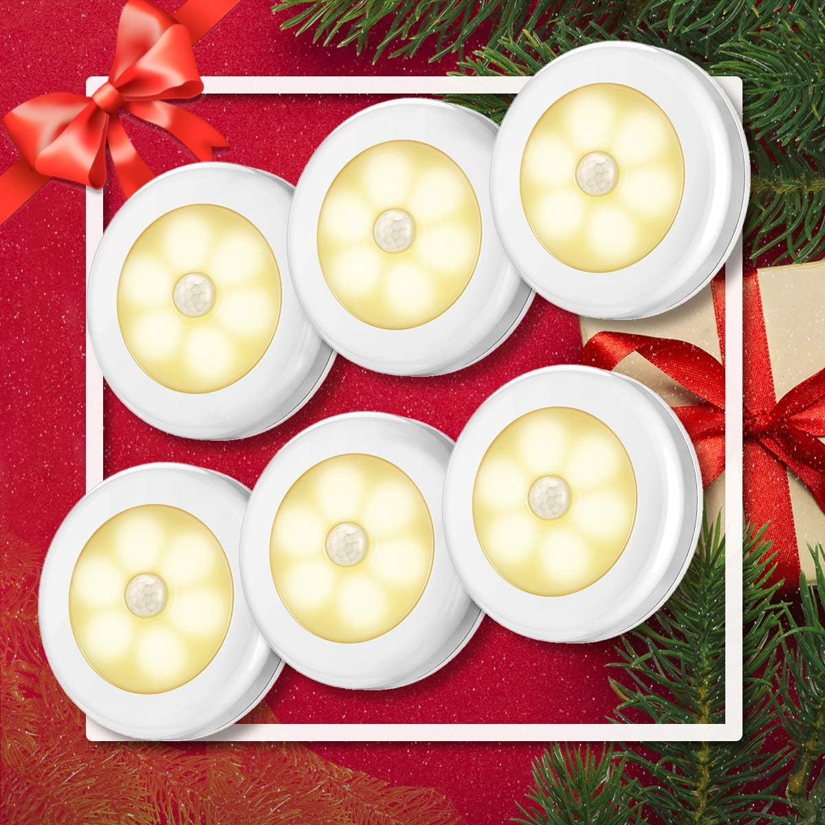 Sechs weiße, runde Lichter mit Sensor auf rotem Hintergrund mit Weihnachtsdekorationen.