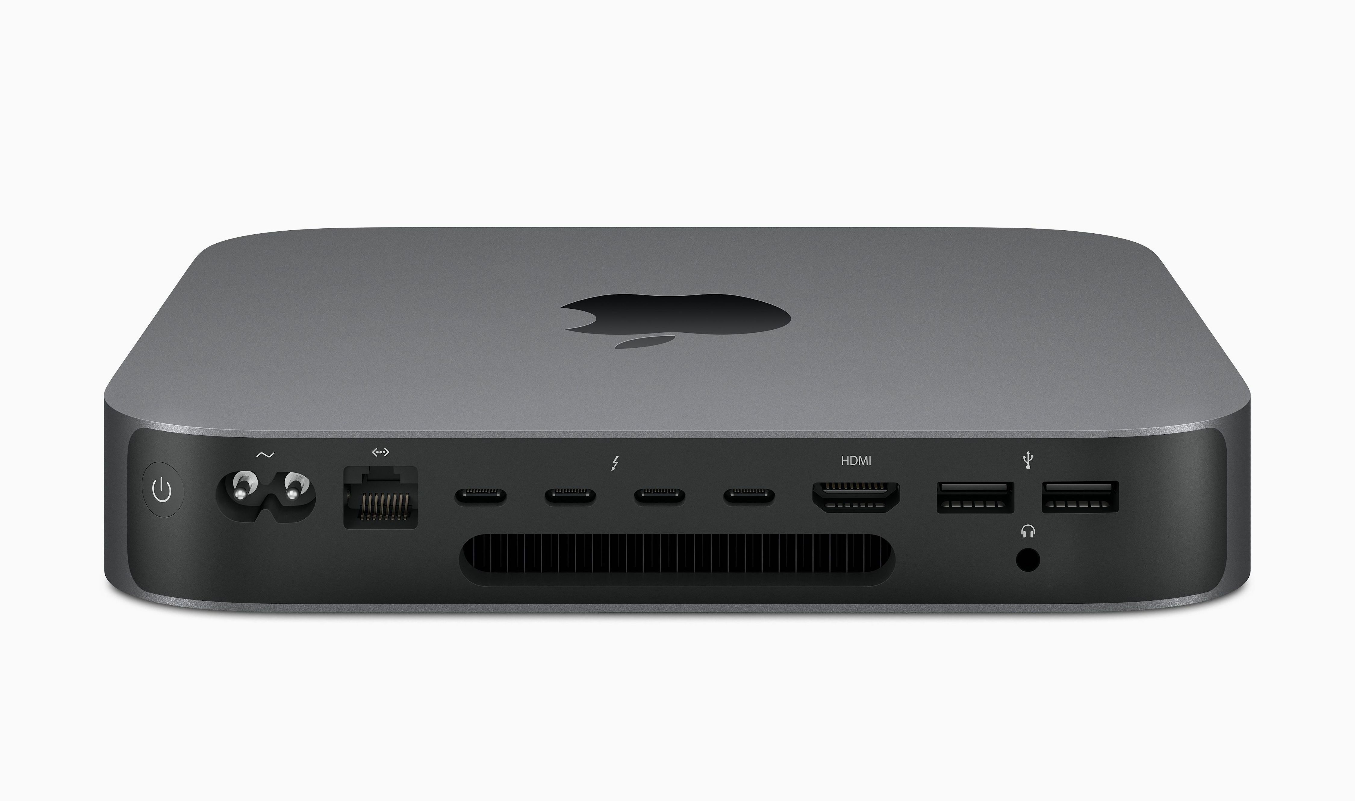 Achteraanzicht van een zilveren Mac Mini-apparaat. Diverse poorten en het Apple-logo zijn zichtbaar.