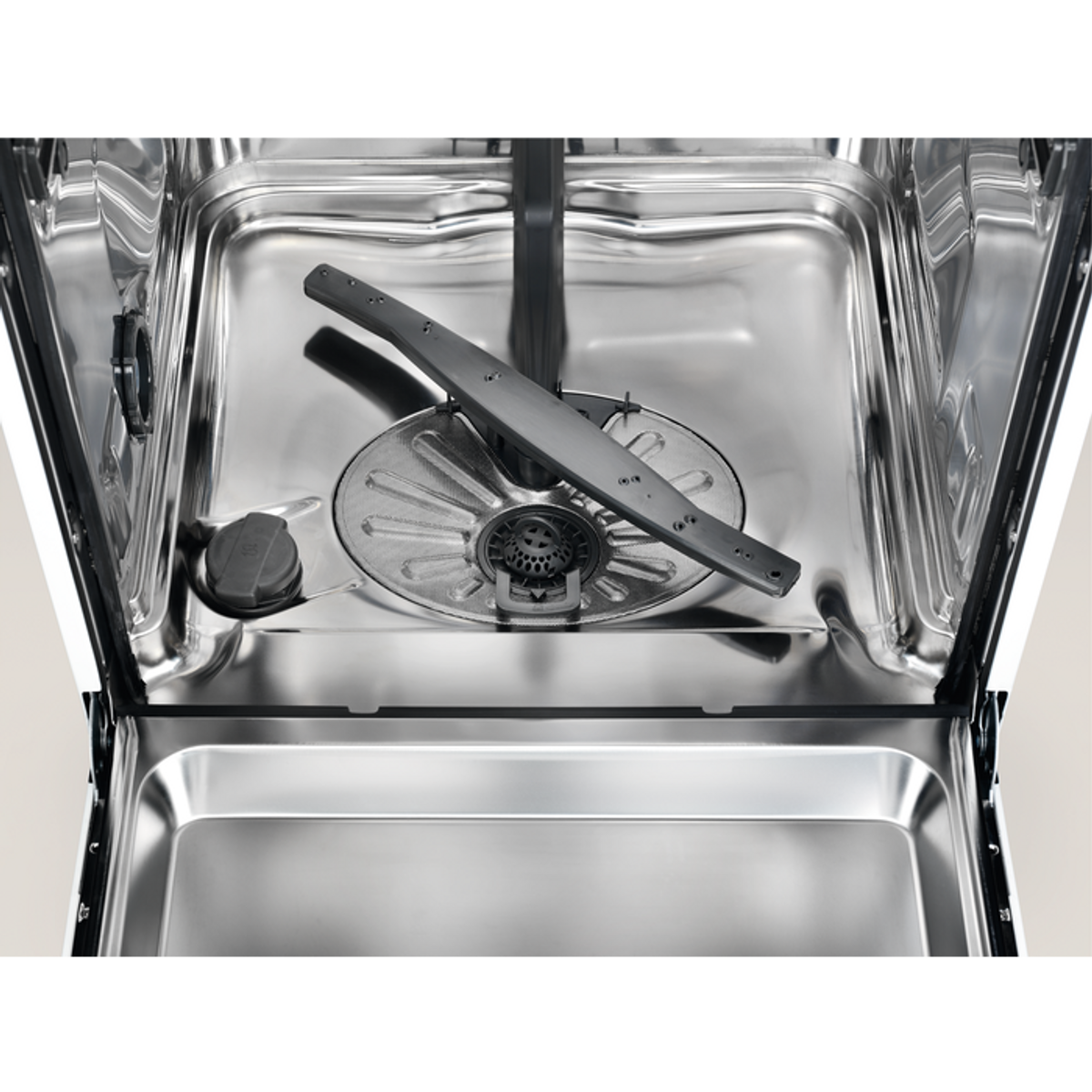 Dishwasher interior, stainless steel. Sprayer arm, and a grey object in the center.