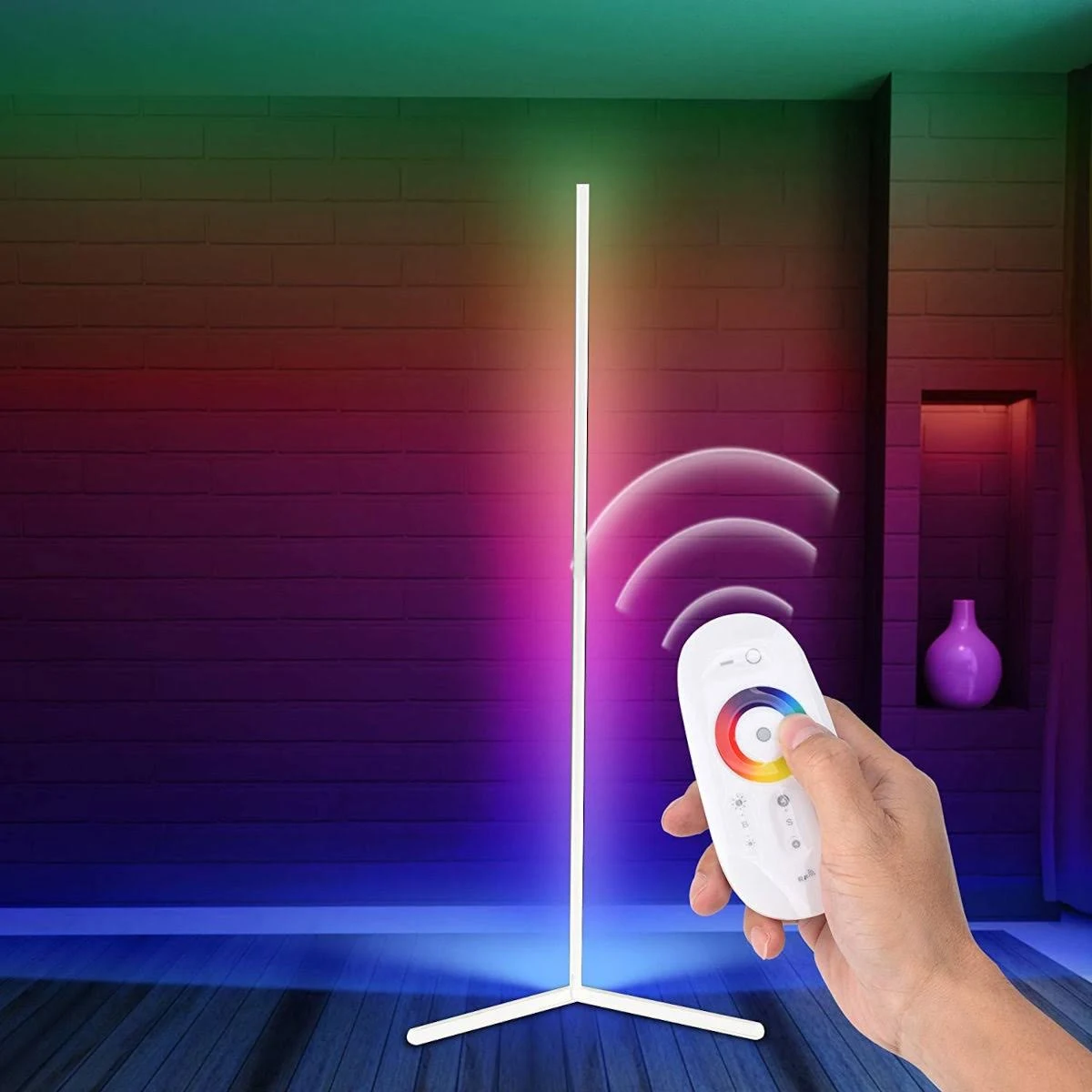 Una lampada verticale con una mano che tiene un telecomando, creando effetti di luce colorati.