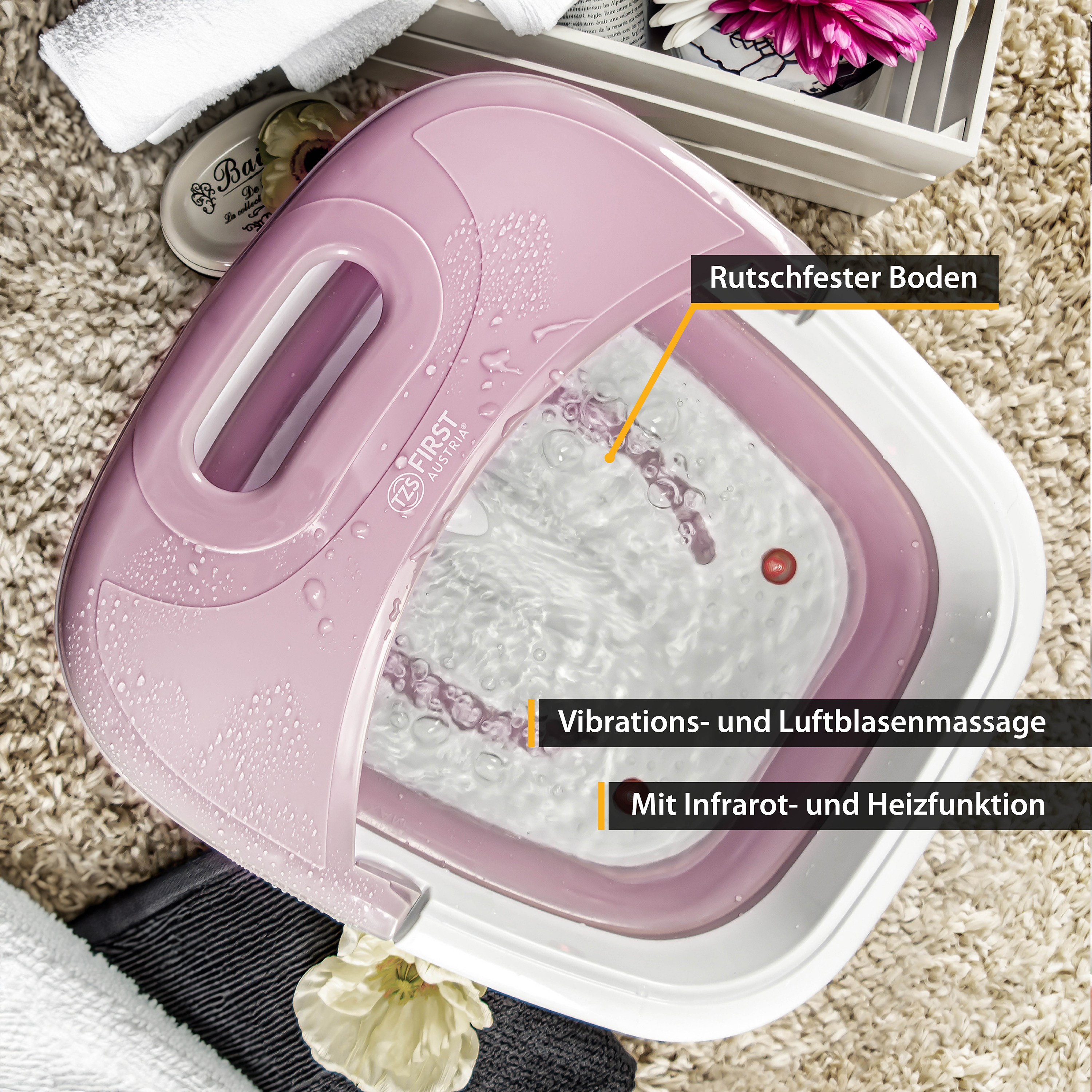 Ein rosa-weißes Fußbad mit Wasser, beschriftet mit 'Vibrationen und Luftblasenmassage' und 'Infrarot- und Heizfunktion'.