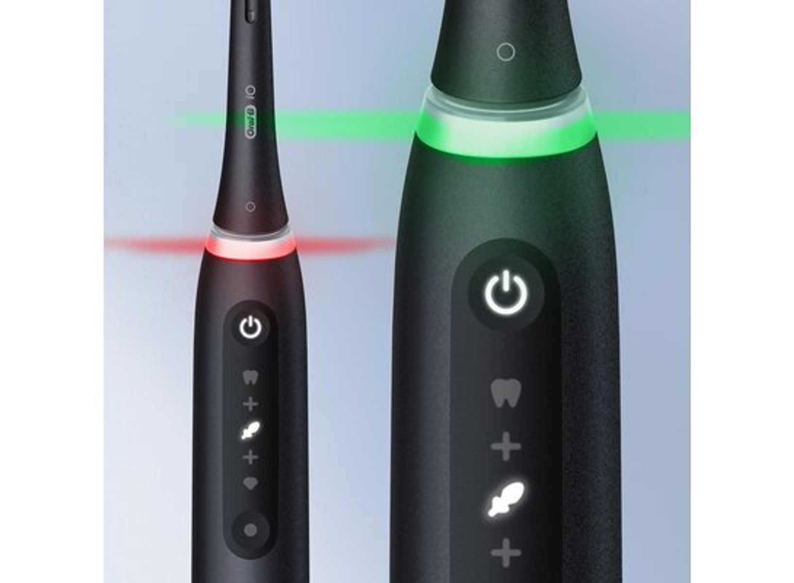 Zbliżenie czarnej elektrycznej szczoteczki do zębów z czerwonymi i zielonymi światłami.