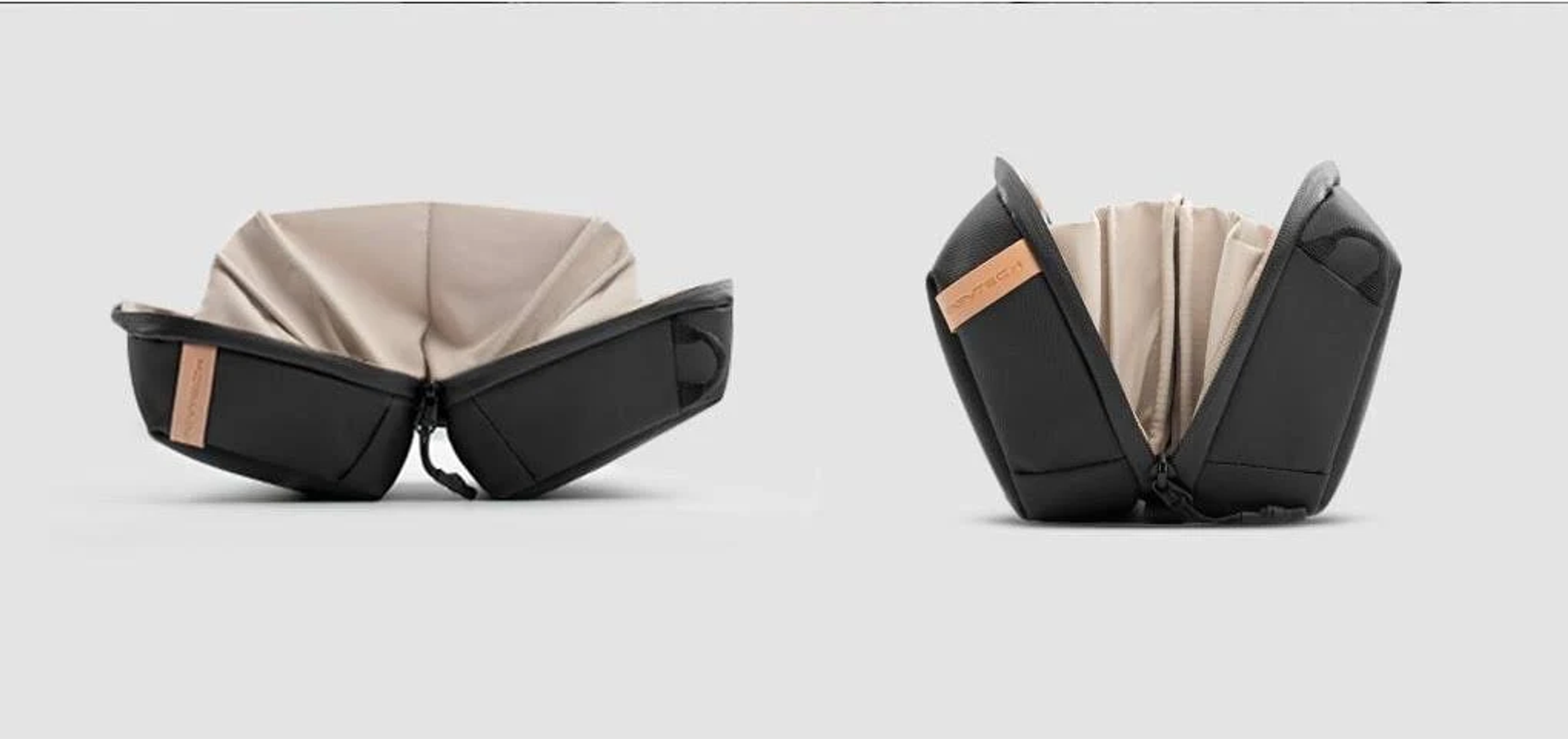 Zwei offene schwarze Taschen mit hellbraunem Innenraum, vor hellem Hintergrund dargestellt.