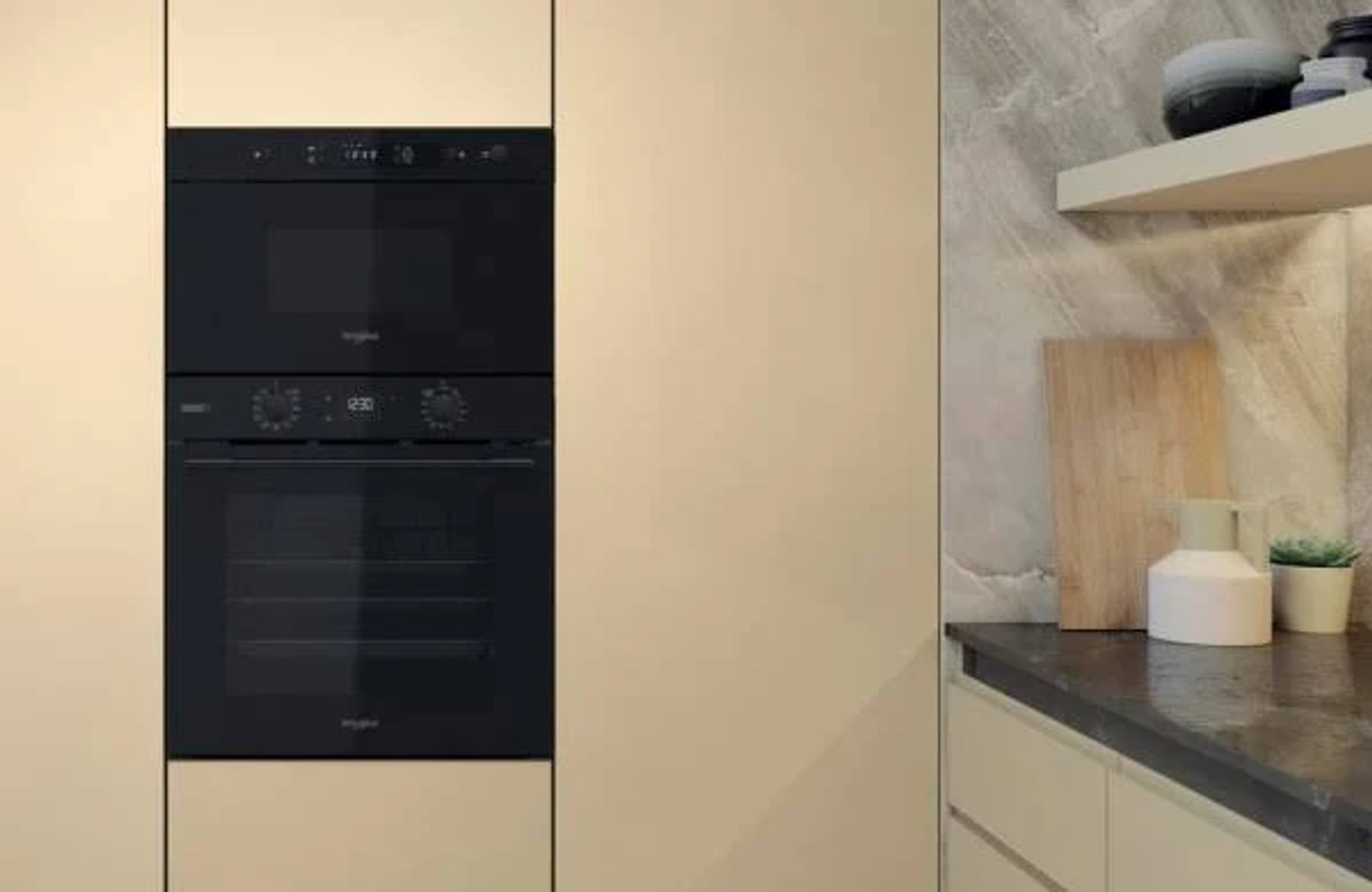 Built-in microwave and oven in a kitchen setting. Beige cabinet doors and a stone countertop.