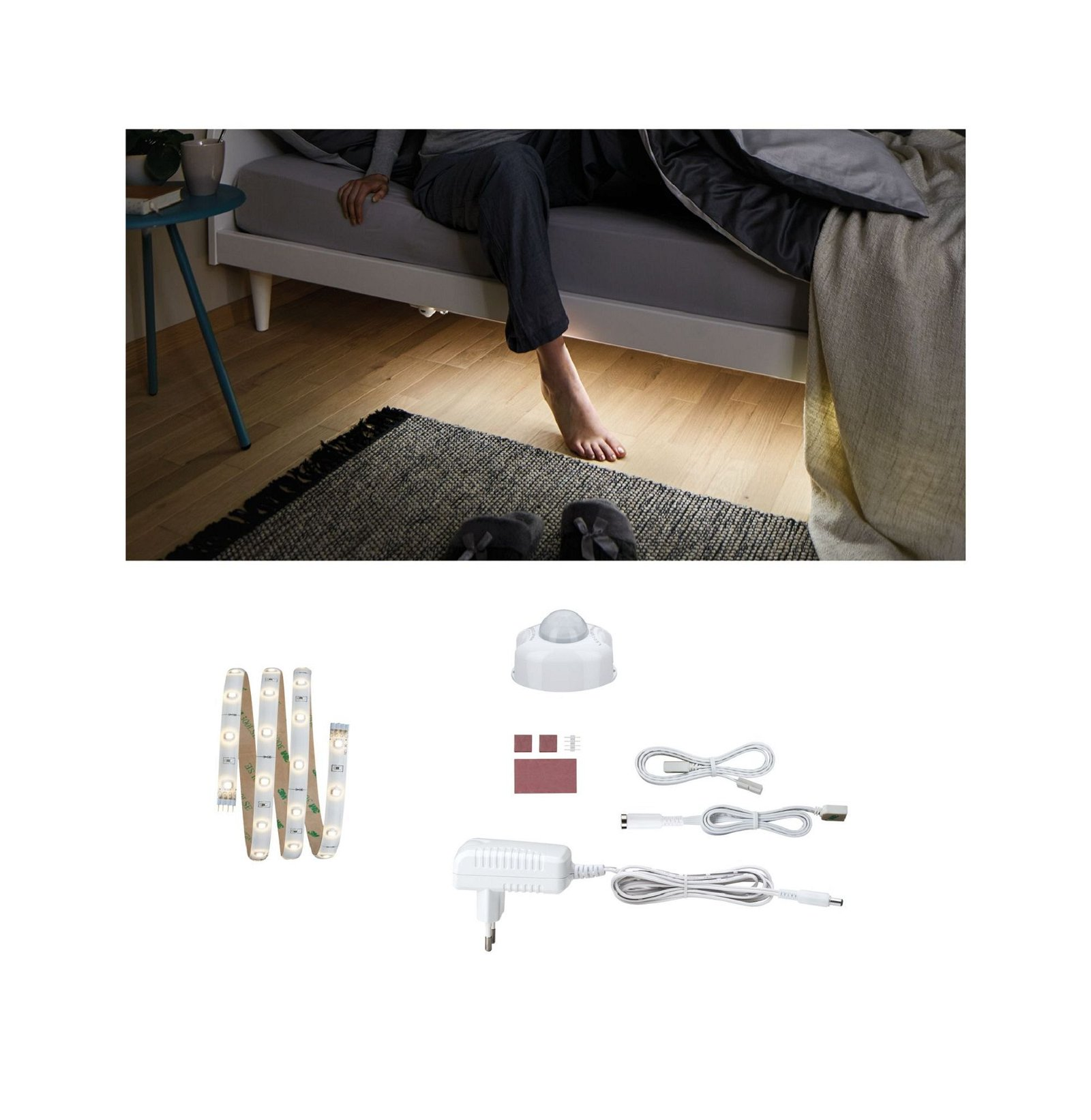 I piedi di una persona vicino a un letto, con strisce LED e componenti.