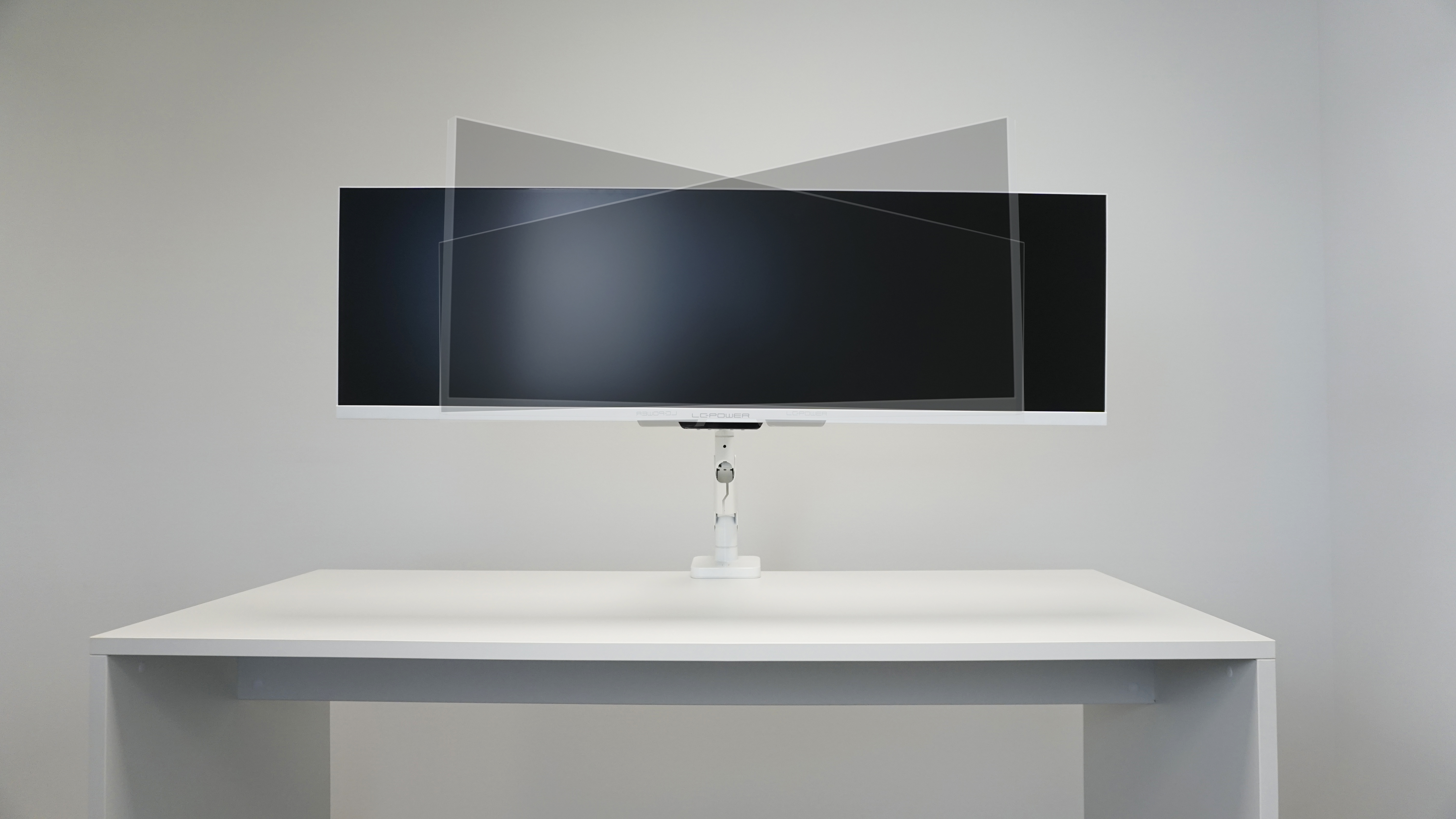 Ein weißer Schreibtisch mit einem Monitor mit Schutzbildschirm.