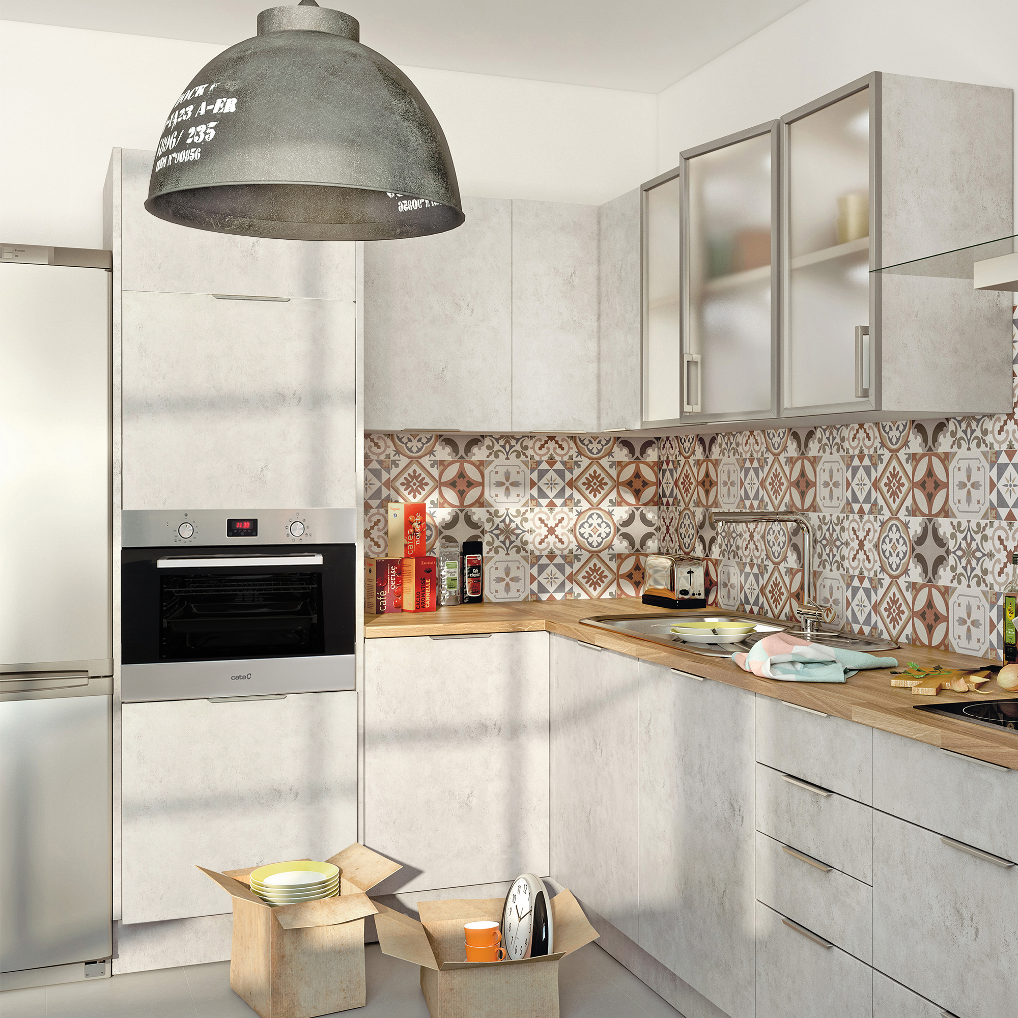 Interno cucina con mobili, forno e una scatola di oggetti.