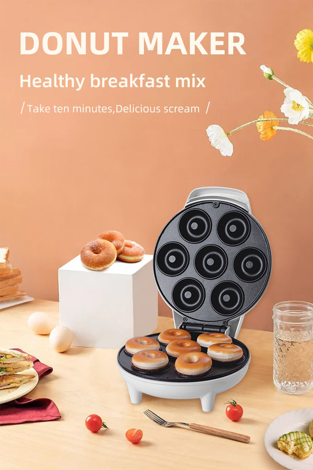 Ein Donut-Maker mit Donuts, die gebacken werden, umgeben von Zutaten und fertigen Donuts.