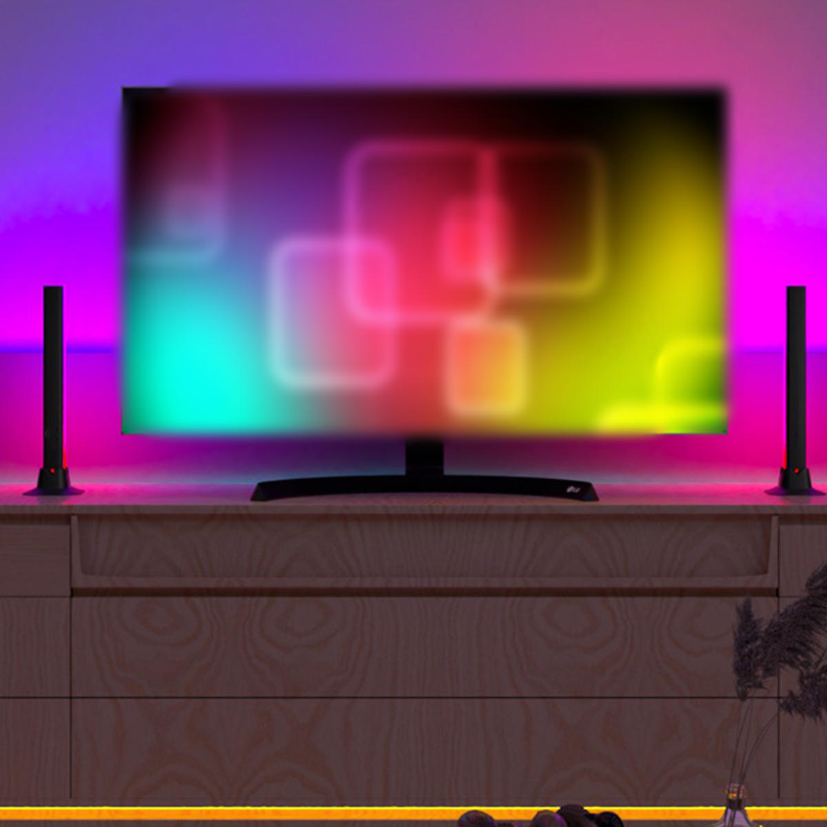 Fernseher auf einem Holzschrank, mit bunten Lichtern dahinter. Zwei Lautsprecher flankieren den Bildschirm. Warme Beleuchtung.