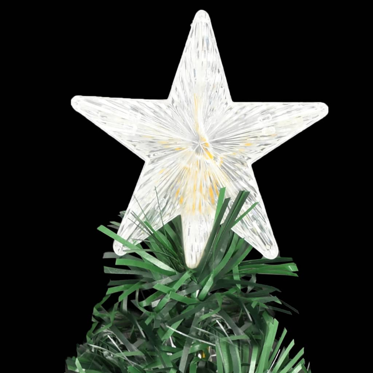 Ein sternförmiger Weihnachtsbaumschmuck. Der Stern ist weiß und beleuchtet, auf grünen Ästen.