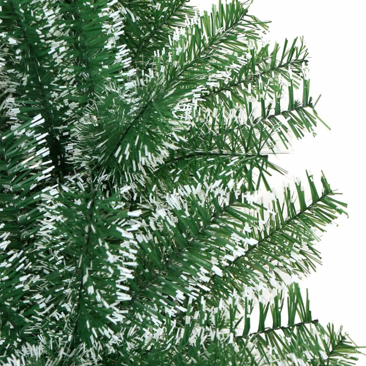 Nahaufnahme von grünen Weihnachtsbaumzweigen mit weißen Akzenten. Die Zweige sind dick.