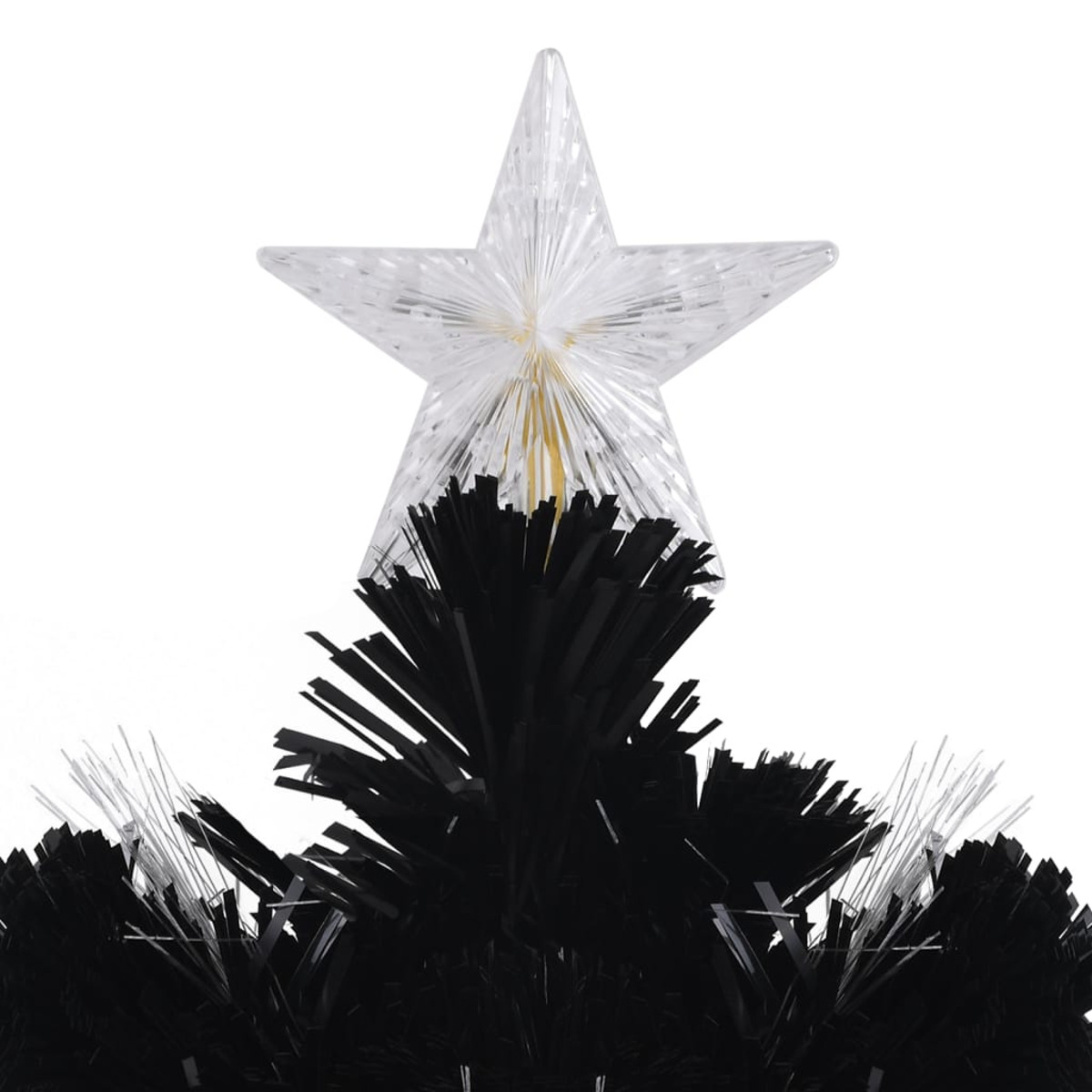 Nahaufnahme eines Sterns auf einem schwarzen Weihnachtsbaum, darunter schwarze Äste.