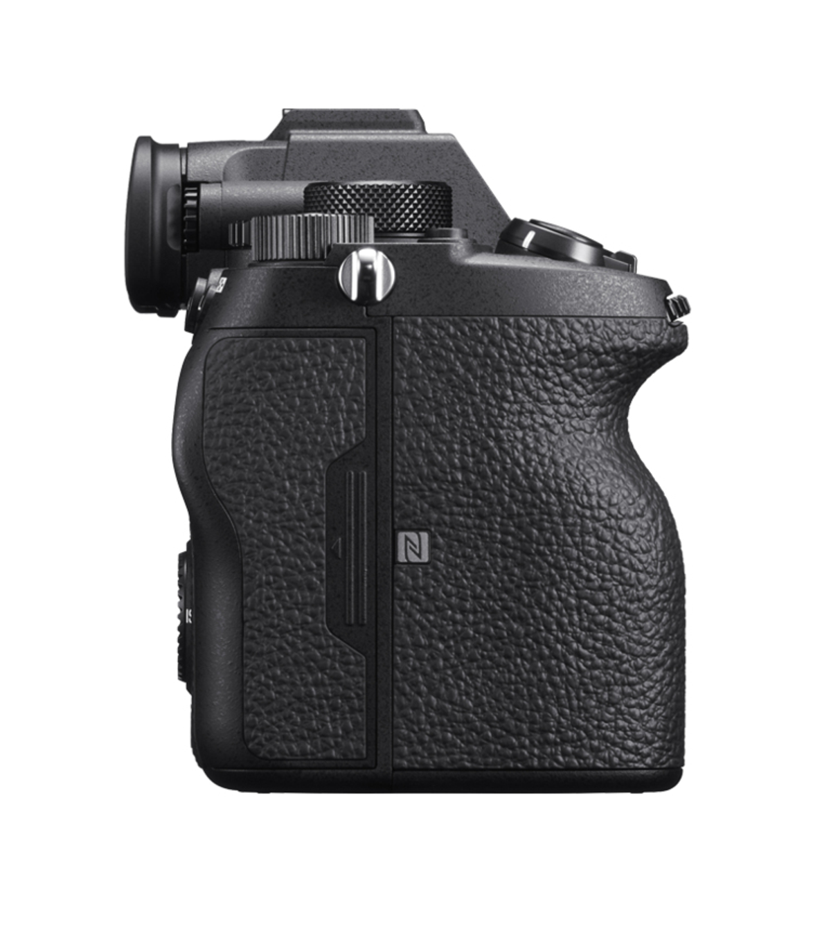 Black camera, side view. Textured grip. Lens and control dials visible.