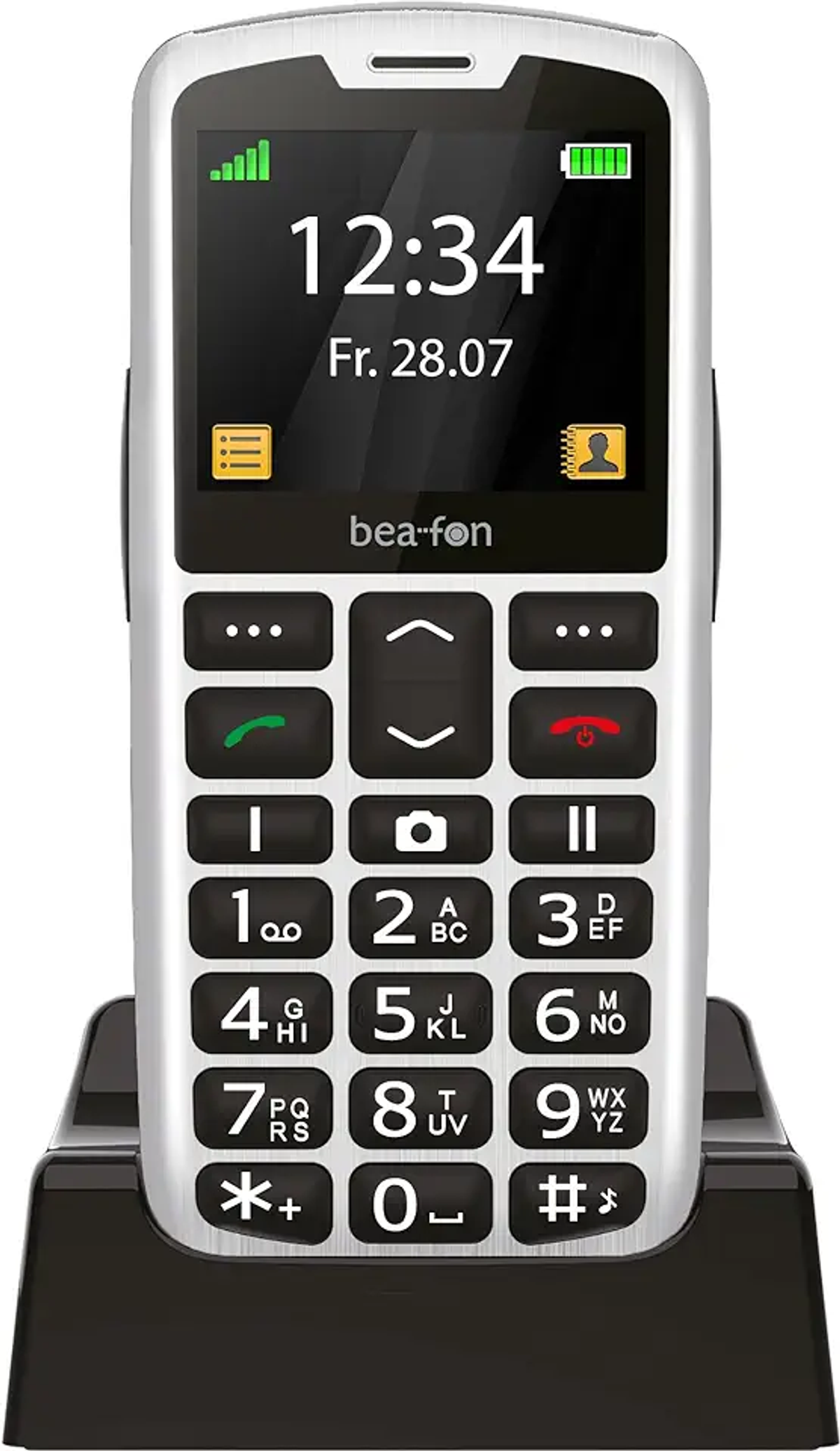 Ein silbernes und schwarzes Bea-Fon-Mobiltelefon, das Uhrzeit und Datum anzeigt. Es hat große Tasten und steht auf einer schwarzen Ladestation.