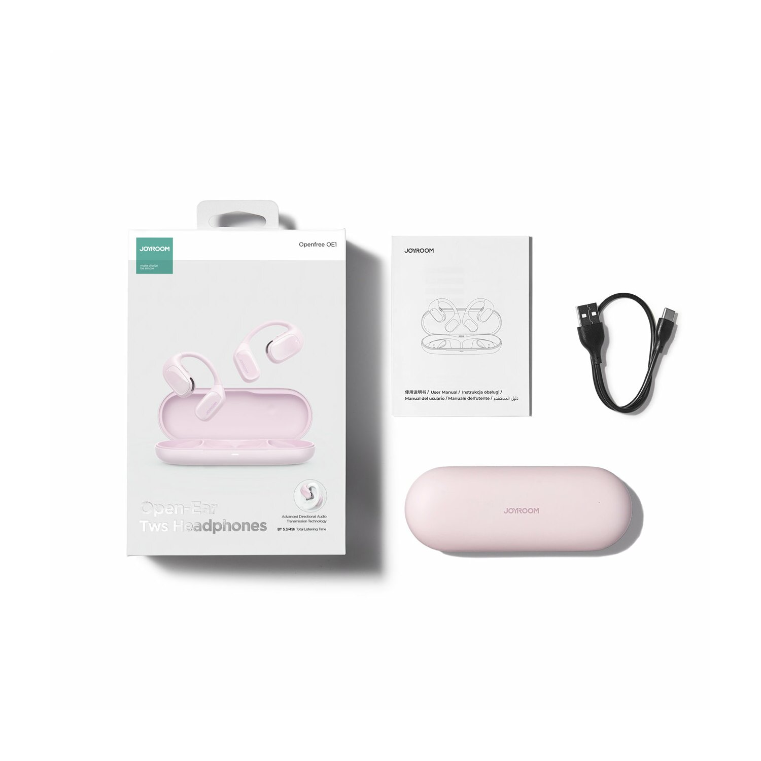 Cuffie open-ear, custodia di ricarica e accessori disposti su una superficie bianca su sfondo bianco.