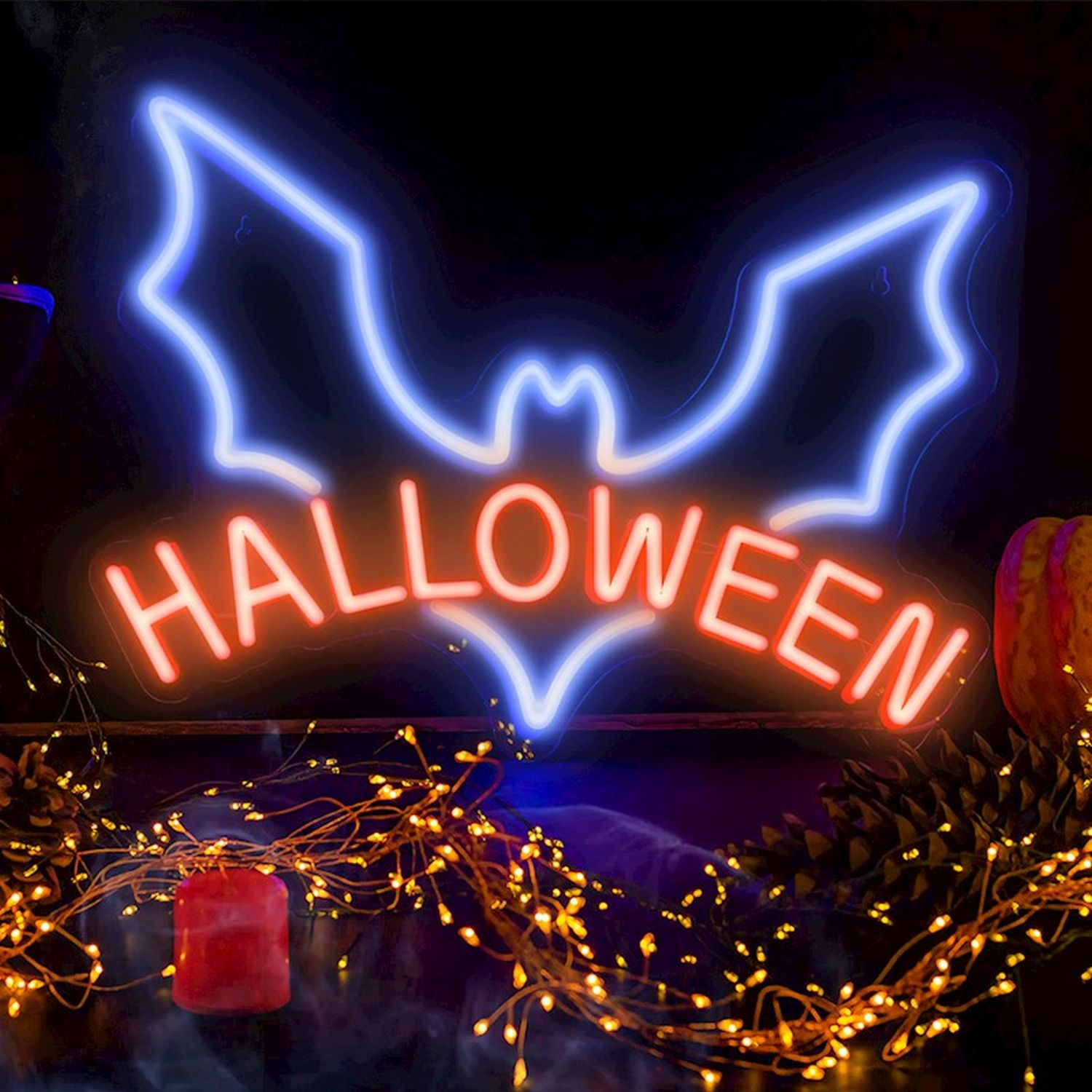 Ein Neon-Fledermaus- und "HALLOWEEN"-Schild. Orangefarbene Lichter und ein Kürbis befinden sich unten.