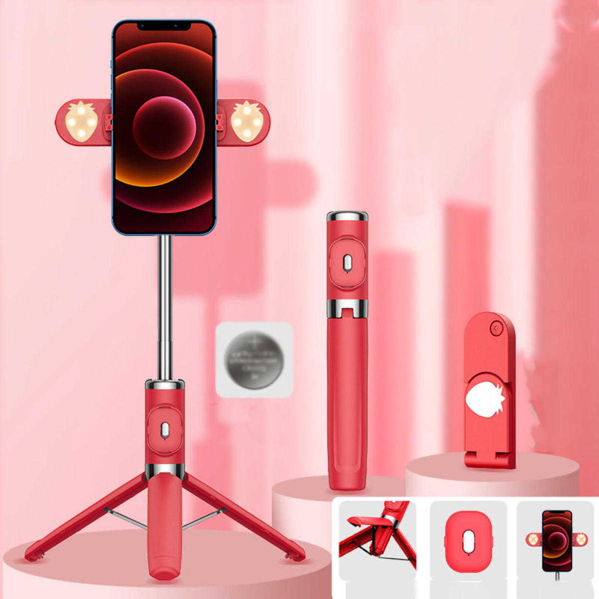 Roter Selfie-Stick mit Telefon, Stativ und Zubehör. Erdbeerlichter am Telefonhalter.