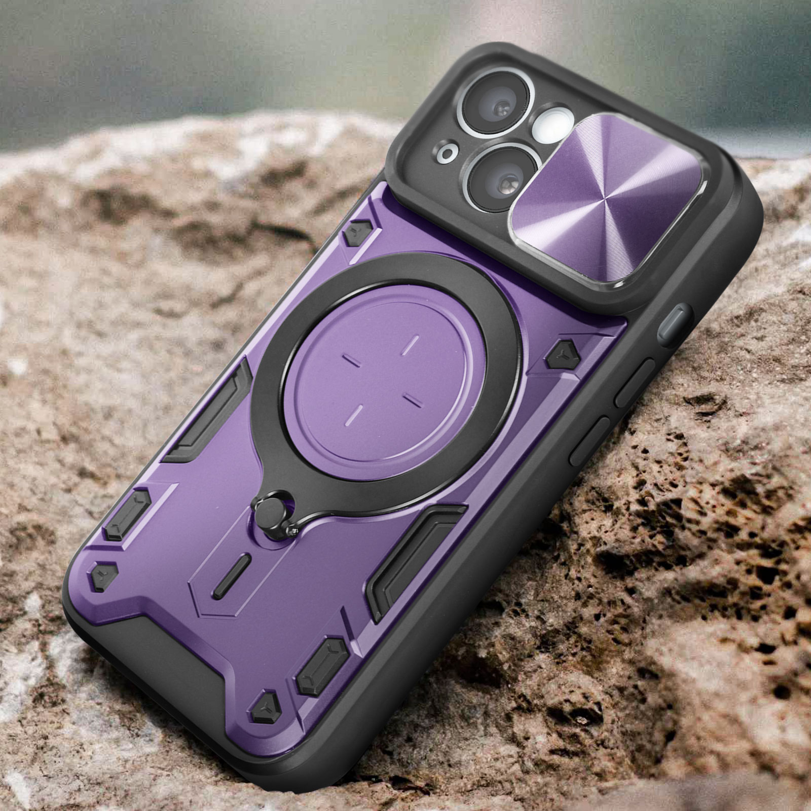 Custodia per telefono viola e nera con anello magnetico. È appoggiata su una superficie rocciosa.